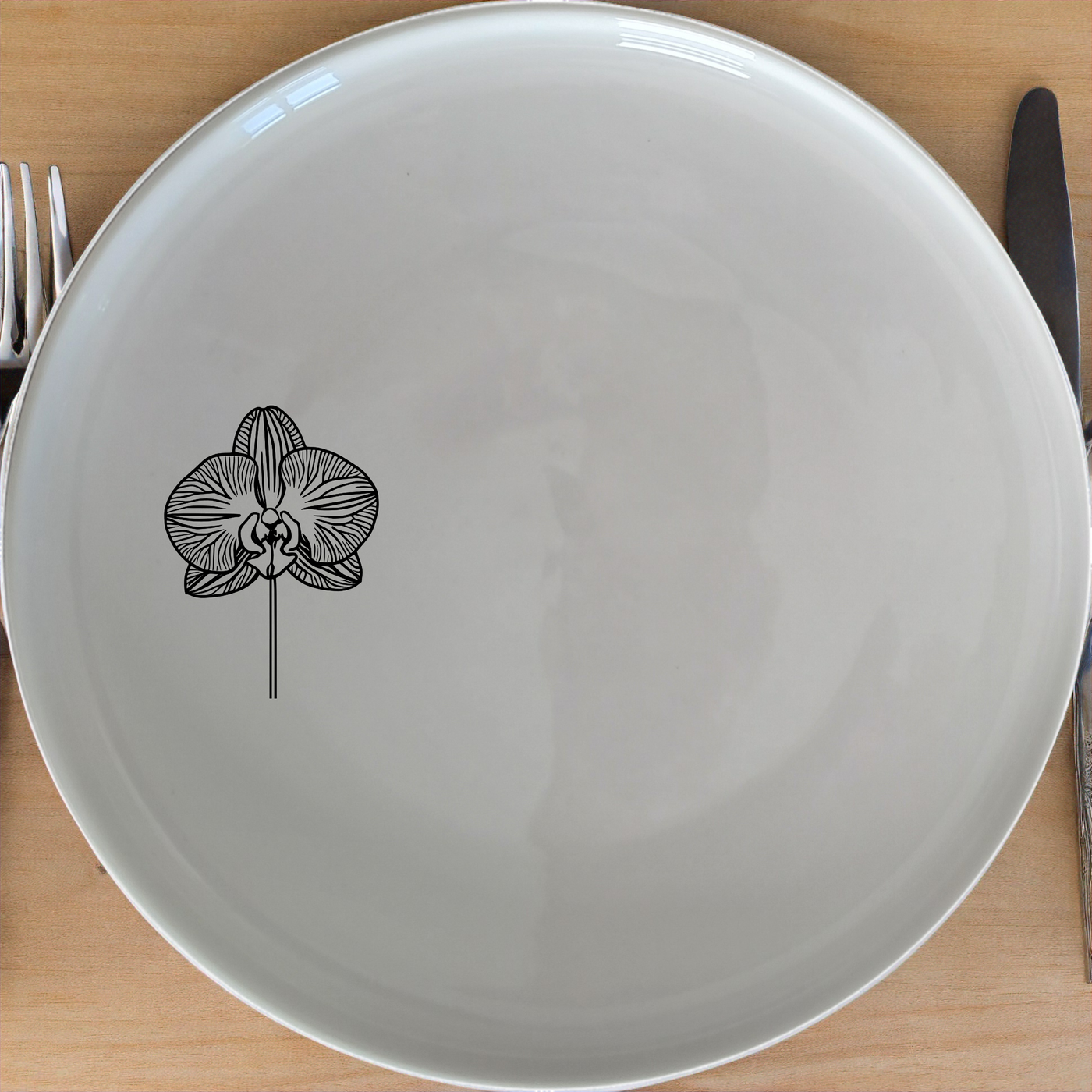 The Orchid Side Plate Set brings a touch of elegance to your dining table with its delicate laser-etched orchid design.