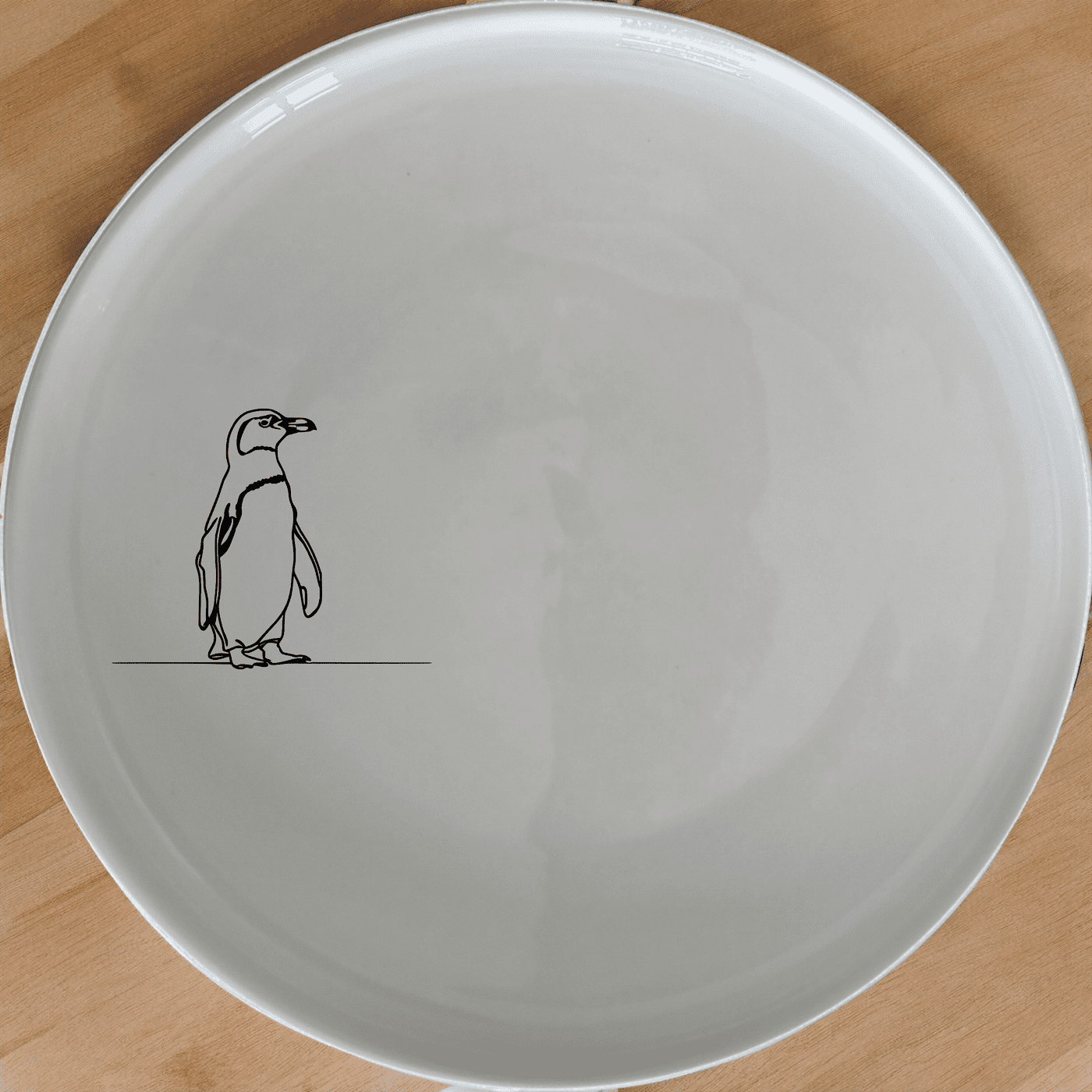The African Penguin Dinner Plate Set of 4 features minimalist penguin silhouettes, perfect for modern dining and everyday use.