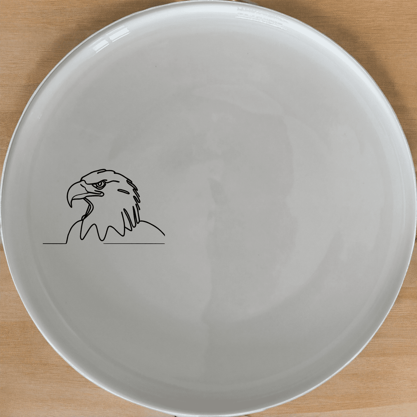 American Bald Eagle Side Plate Set of 4 features a minimalist design perfect for modern dining. This set of four plates showcases a sleek eagle silhouette, making it an ideal choice for both everyday use and special occasions.