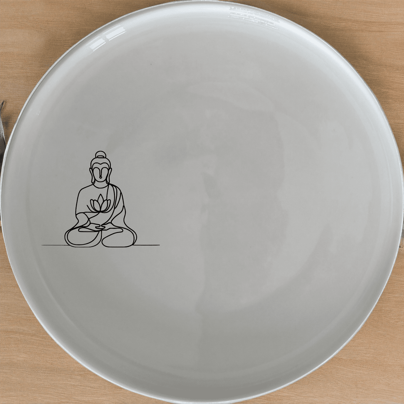 The Budist Imagery Side Plate Set of 4 features a serene design perfect for any dining table. Crafted from durable ceramic, these plates are both stylish and practical.