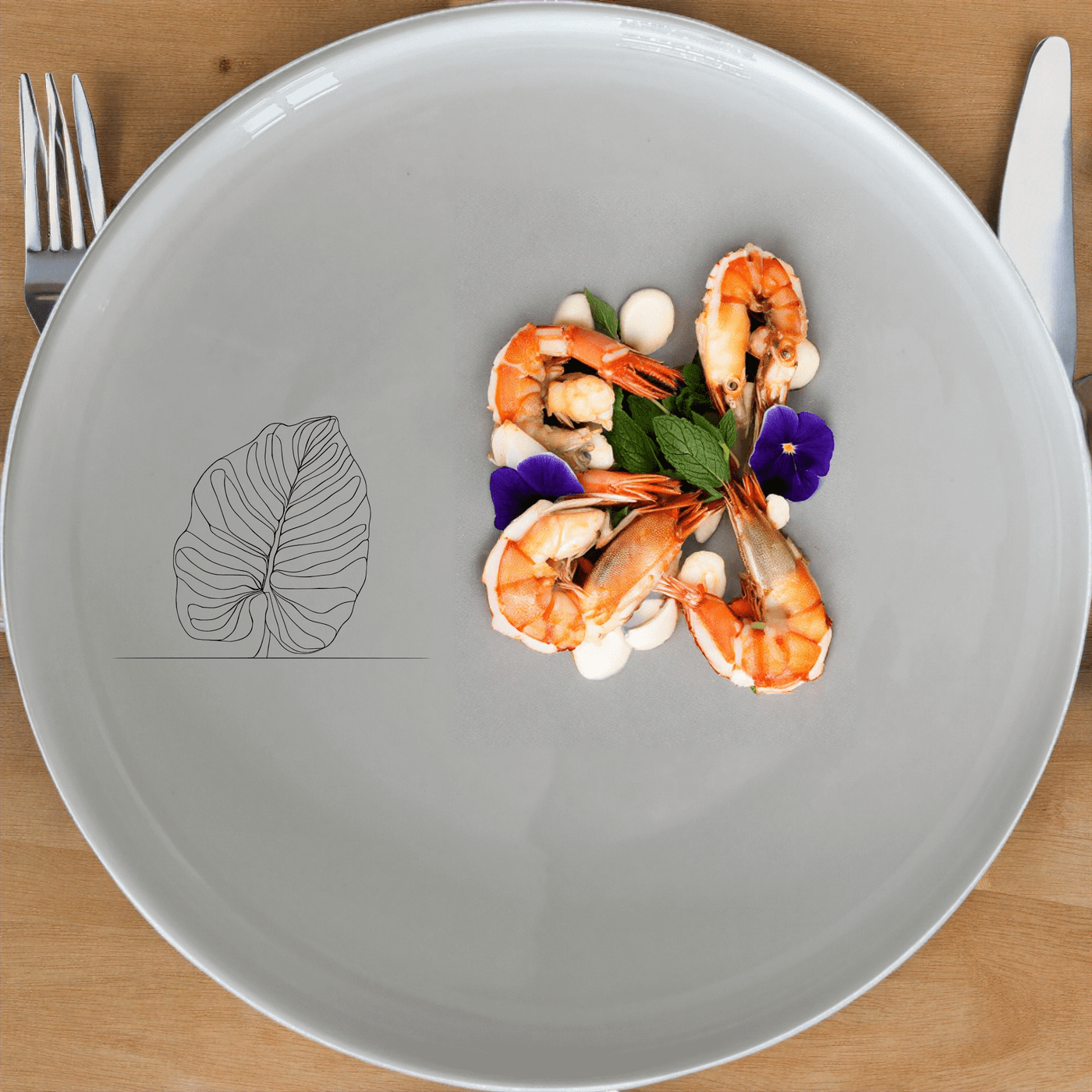 The Calathea Orbifolia Dinner Plate Set of 4 features a minimalist design with a subtle leaf motif, perfect for modern dining settings.