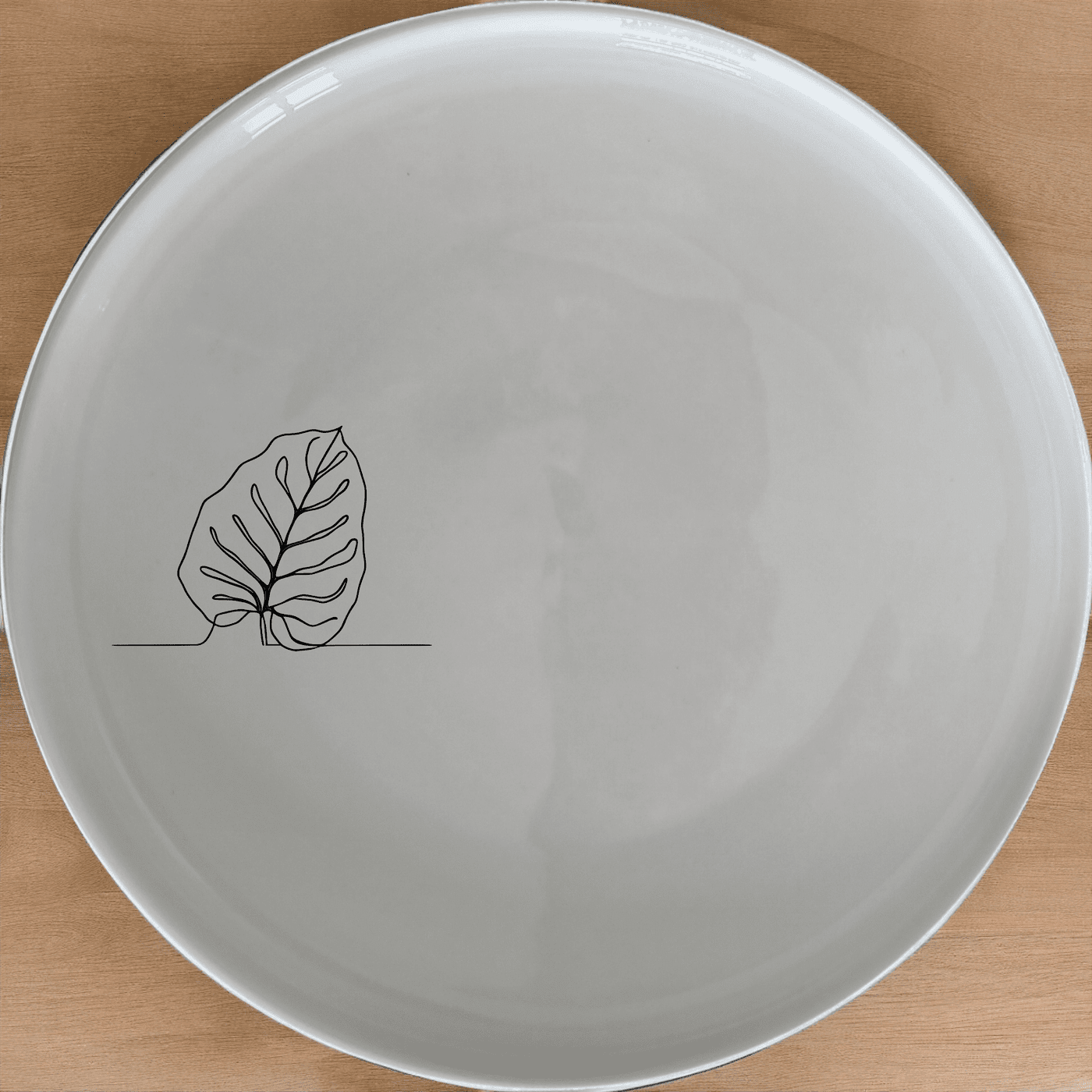 The Orbifolia Leaf Dinner Plate Set of 4 features a minimalist leaf design, perfect for modern dining and everyday use.
