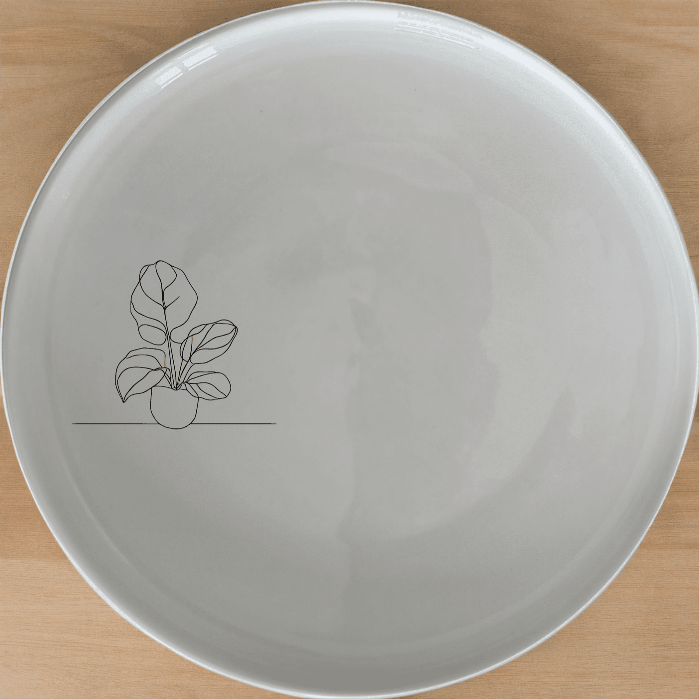 The Orbifolia Leaf Side Plate Set of 4 features a minimalist design with a subtle leaf motif, perfect for modern dining settings.