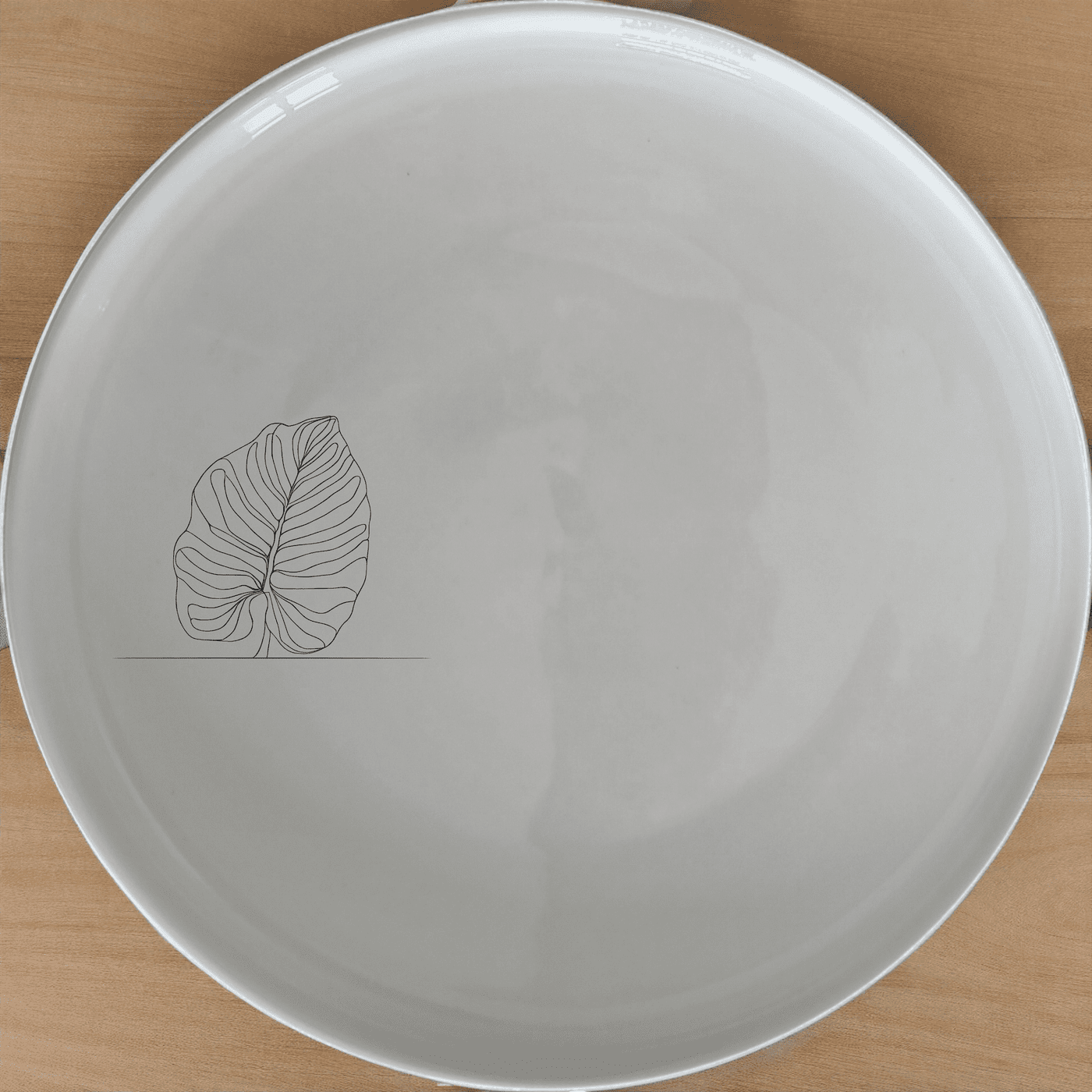 The Calathea Orbifolia Side Plate Set of 4 features a delicate leaf design, perfect for modern dining and everyday use.