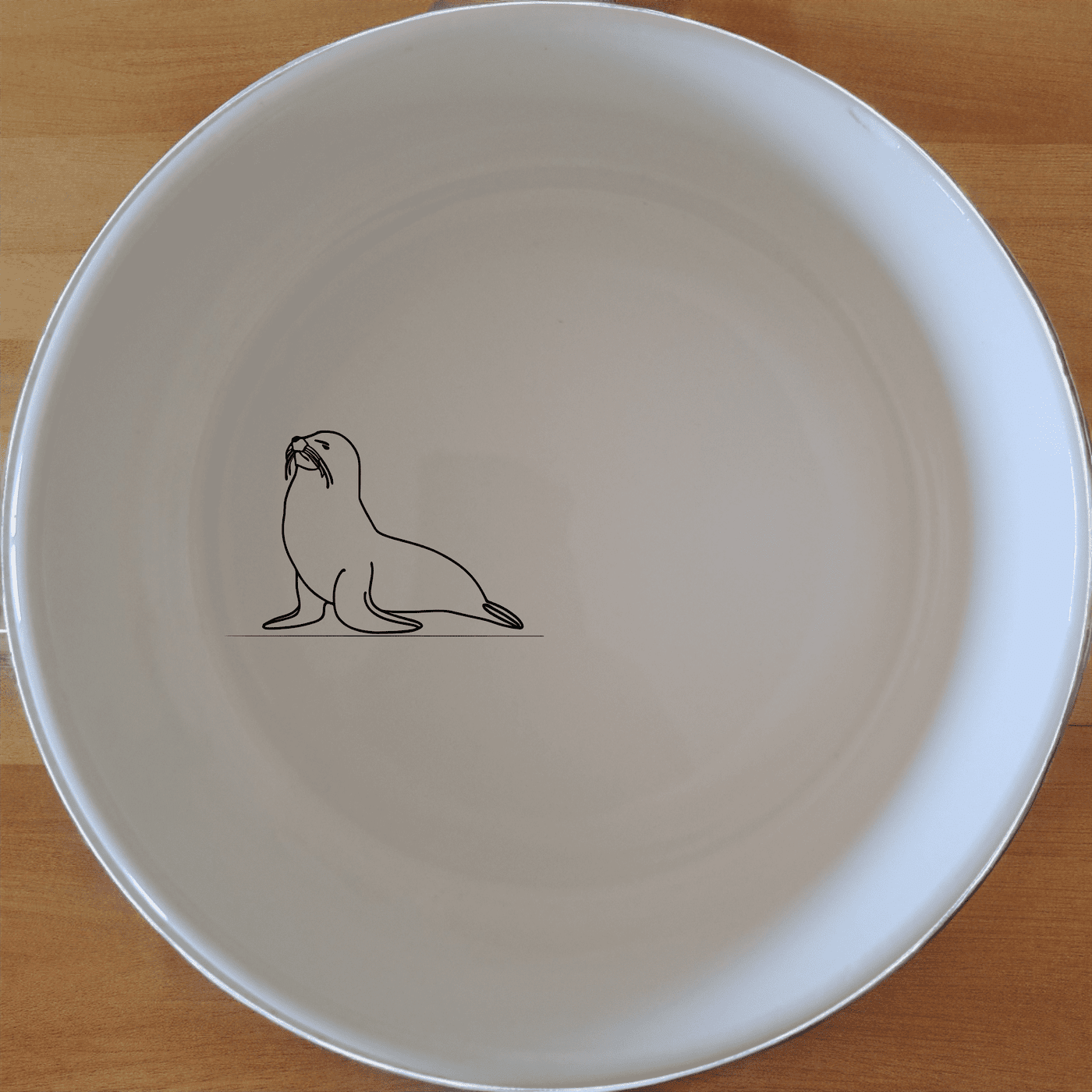 The Cape Fur Seal Bowl Set of 4 features sleek silhouettes on white ceramic, perfect for modern dining and everyday use.
