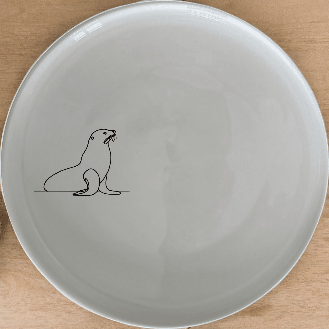 The Cape Fur Seal Dinner Plate Set of 4 features minimalist silhouettes for a modern touch. Perfect for everyday use or special occasions.
