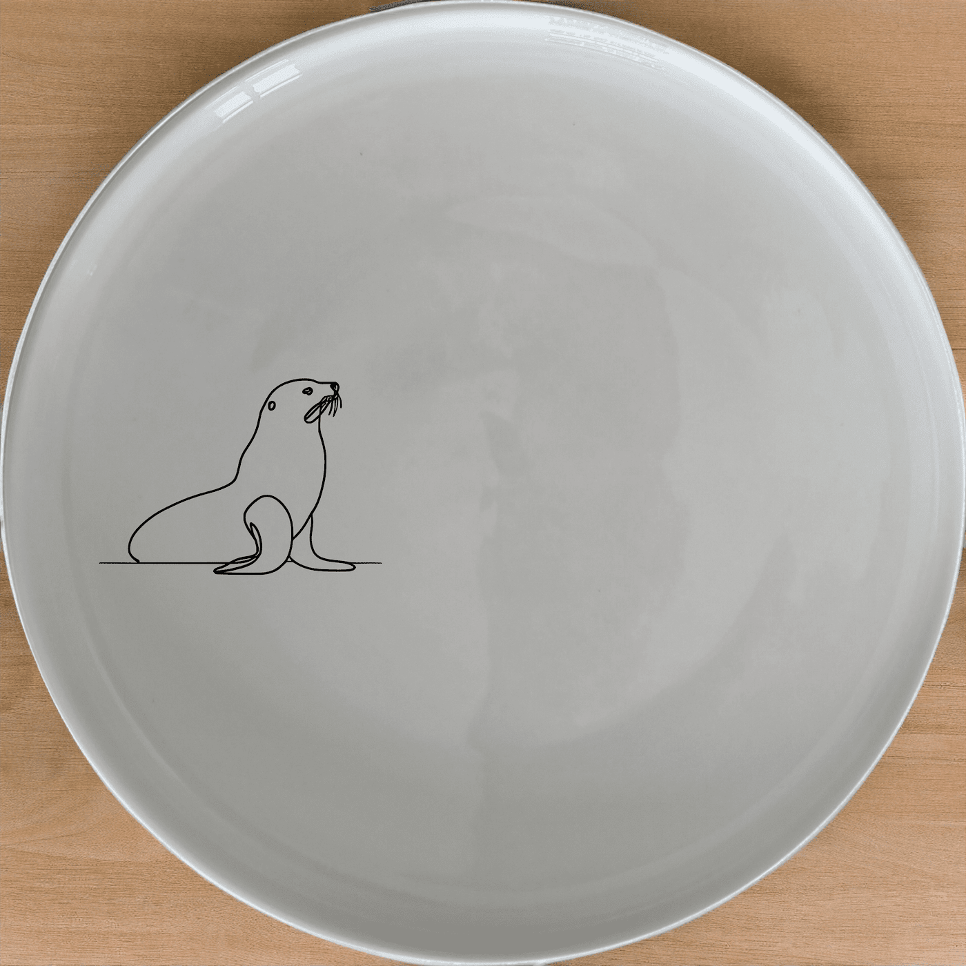 The Cape Fur Seal Side Plate Set of 4 features minimalist silhouettes on white ceramic plates, perfect for modern dining.