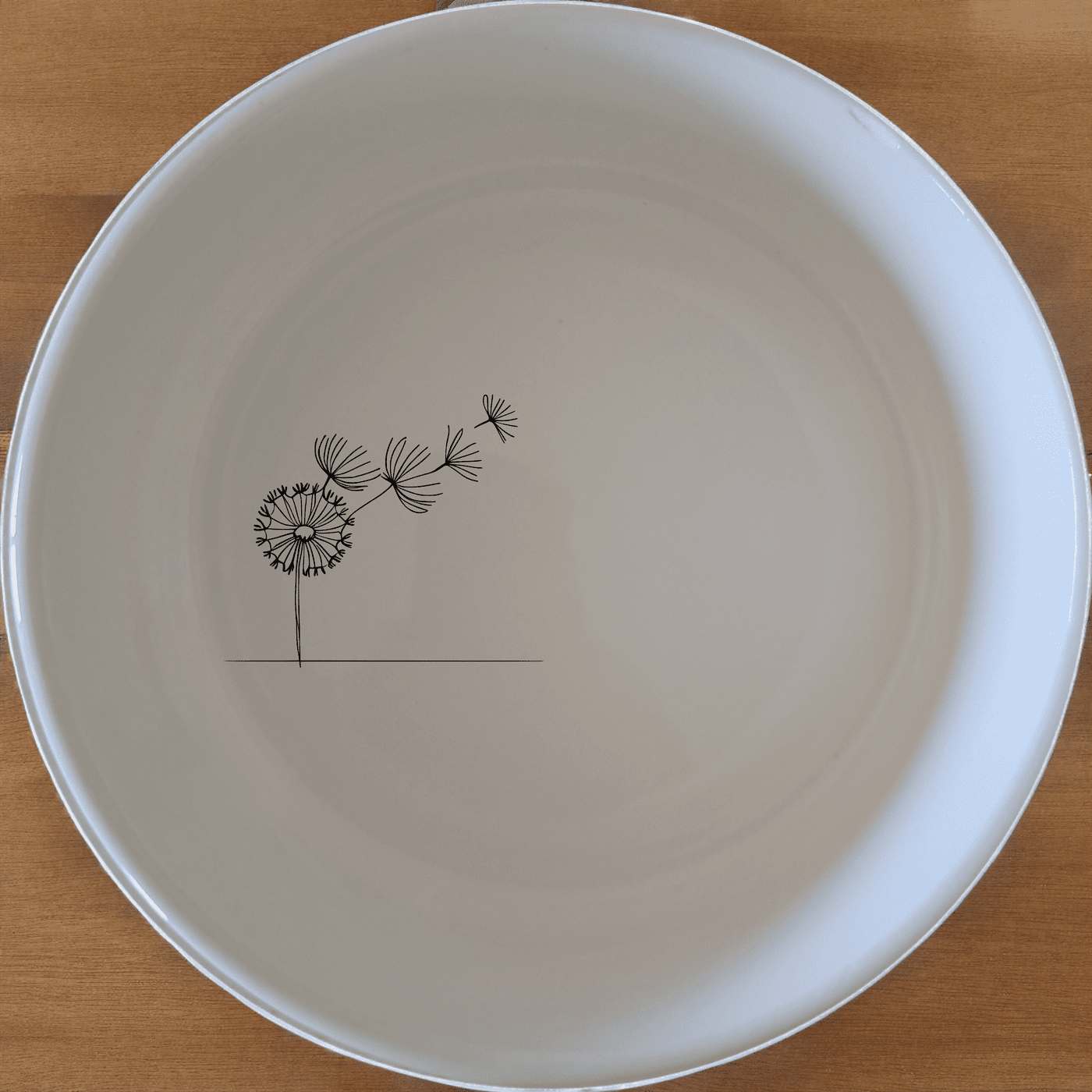 The Dandelion Seeds Wind Bowl Set of 4 features delicate laser-etched designs on white ceramic bowls, perfect for a modern and minimalist dining experience.