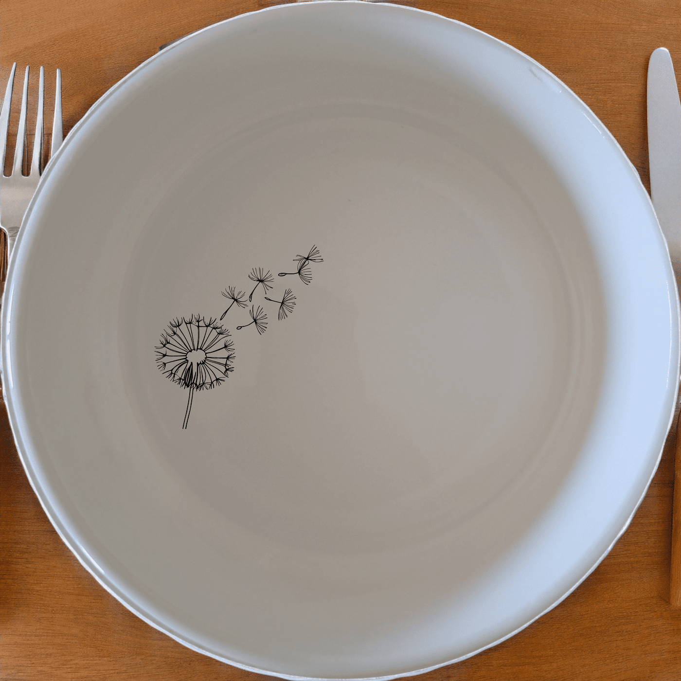 The Dandelion Seeds Wind Bowl Set of 4 features delicate laser-etched designs on white ceramic bowls, perfect for everyday use or special occasions.