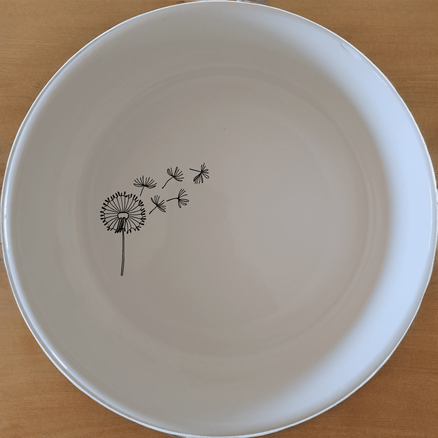 The Dandelion Seeds Wind Bowl Set of 4 features delicate laser-etched designs on white ceramic bowls, perfect for everyday use or special occasions.