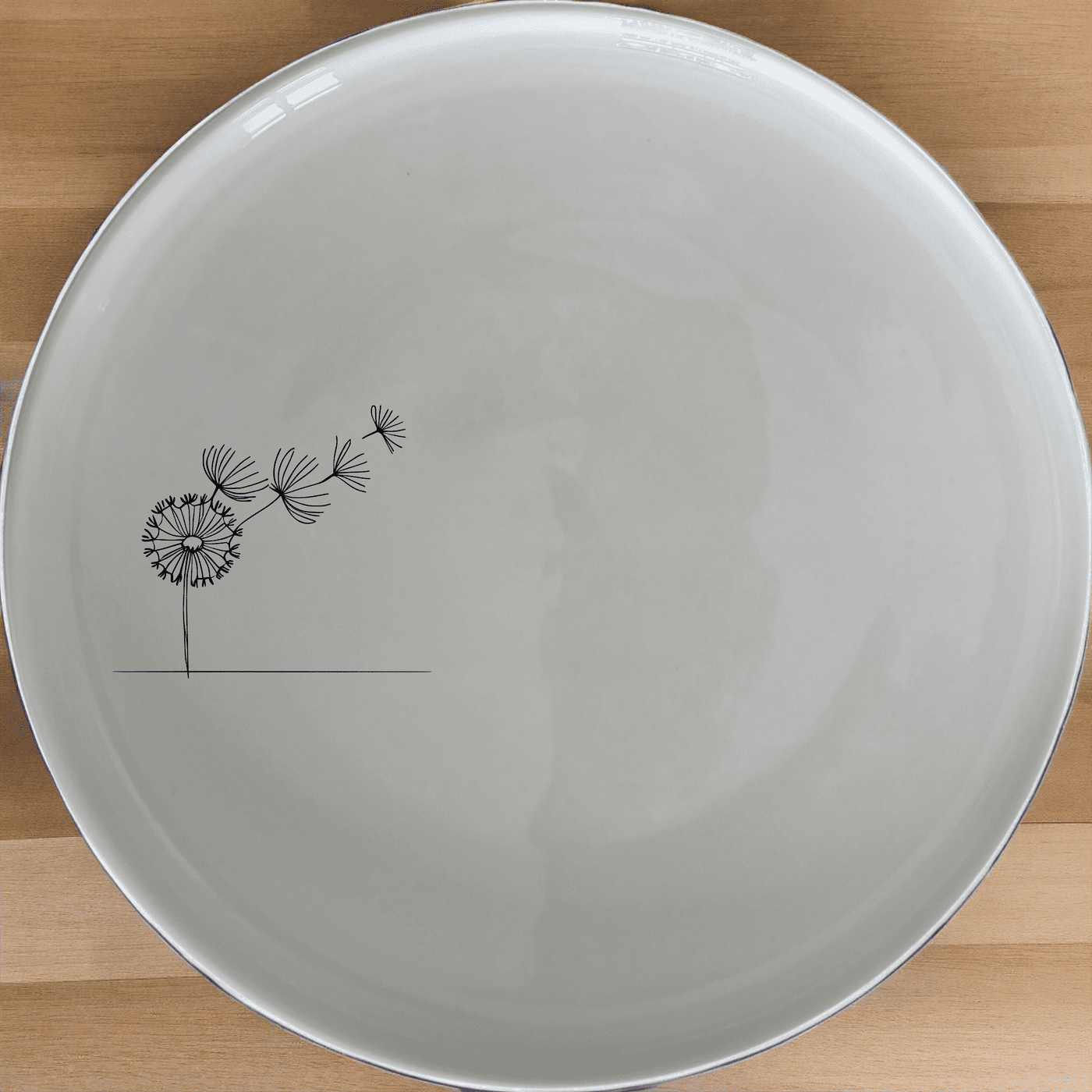 The Dandelion Seeds Side Plate Set of 4 features a delicate laser-etched design, perfect for everyday use or special occasions.
