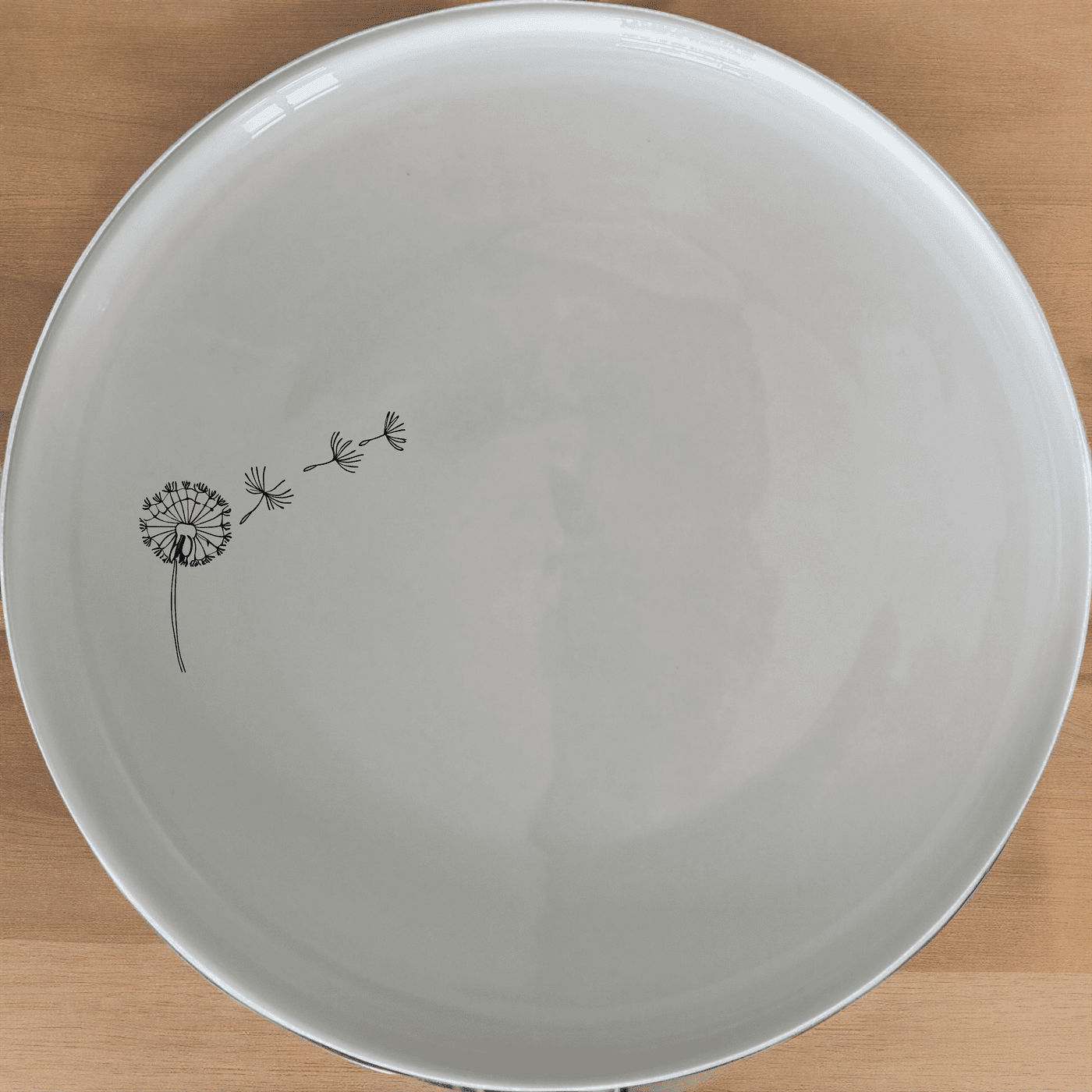 The Dandelion Seeds Wind Dinner Plate Set of 4 adds a touch of nature to your dining table with delicate dandelion designs.