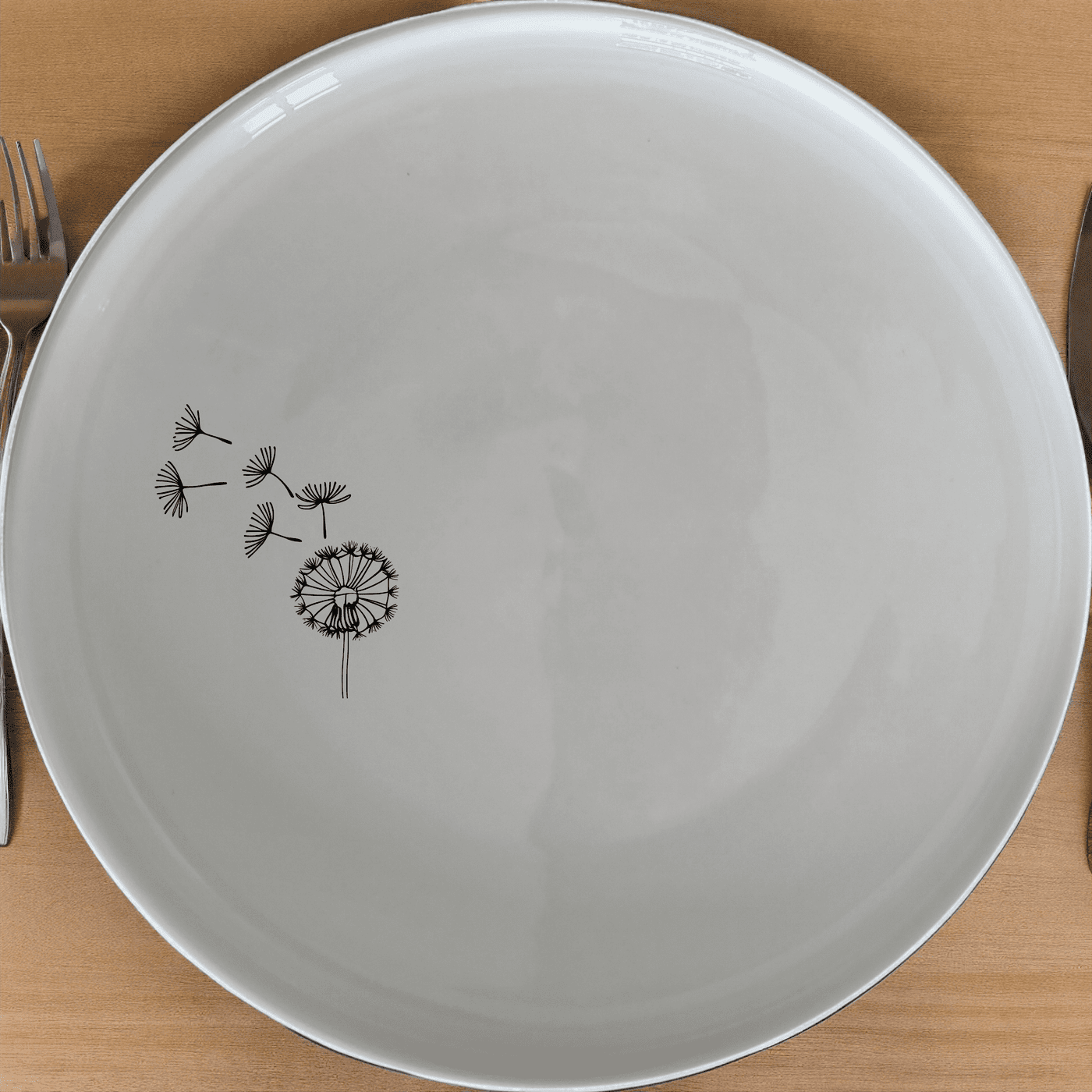 The Dandelion Seeds Wind Dinner Plate Set of 4 features delicate laser-etched designs for a touch of nature-inspired elegance to your dining table.