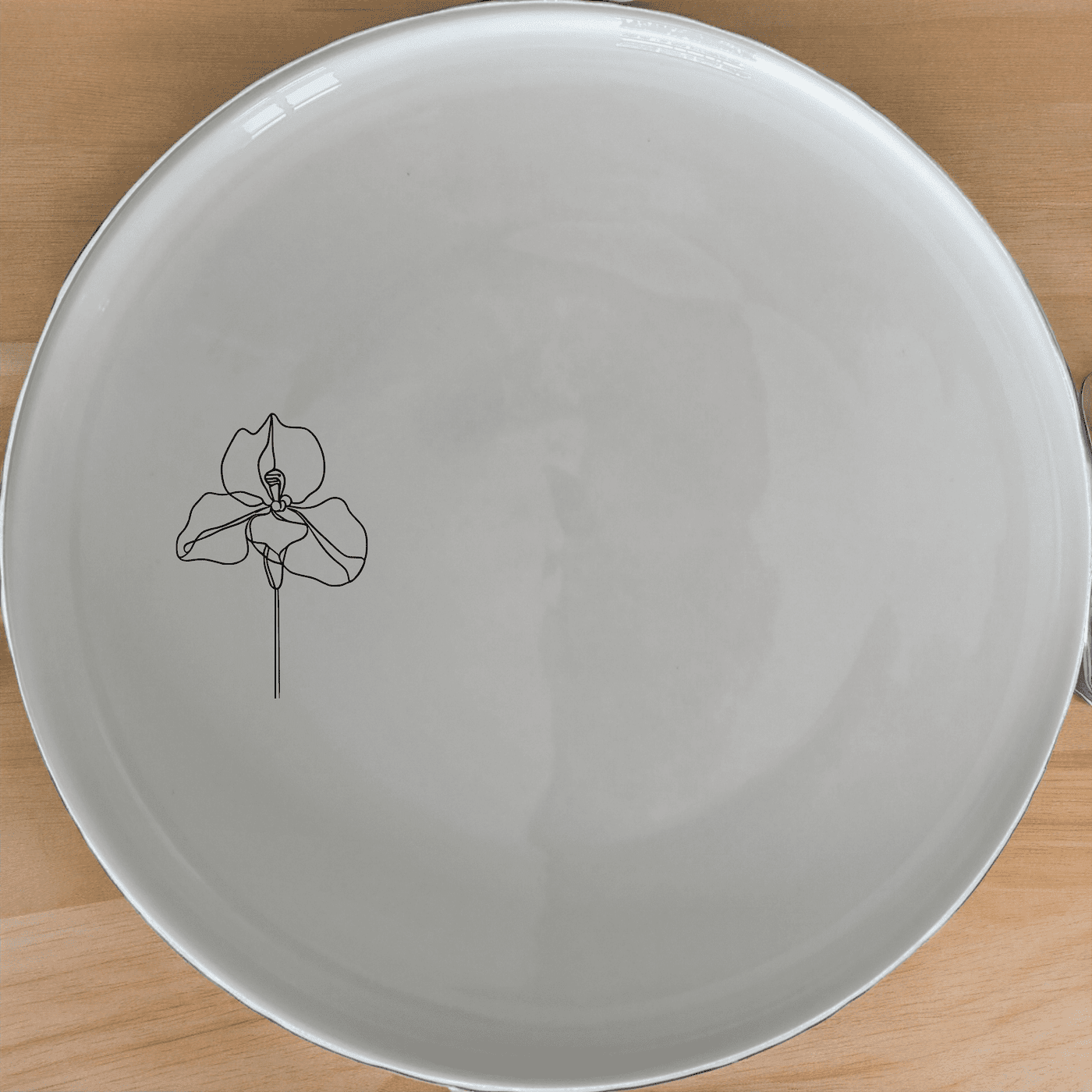 The Delicate Disa Flower Dinner Plate Set of 4 features an elegant laser-etched orchid design on a sleek white ceramic surface, perfect for elevating any dining experience.