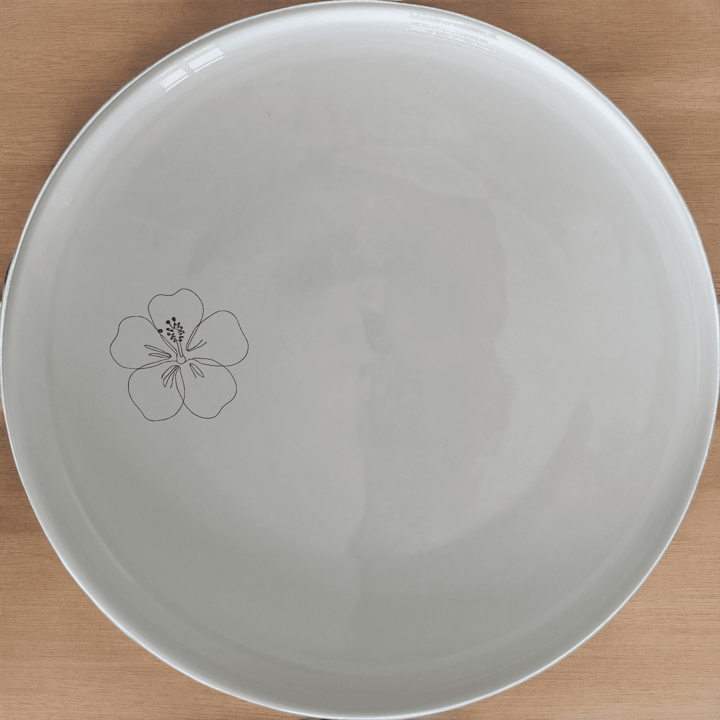 The Delicate Hibiscus Flower Dinner Plate Set of 4 adds a touch of elegance to any dining table with its subtle floral design.