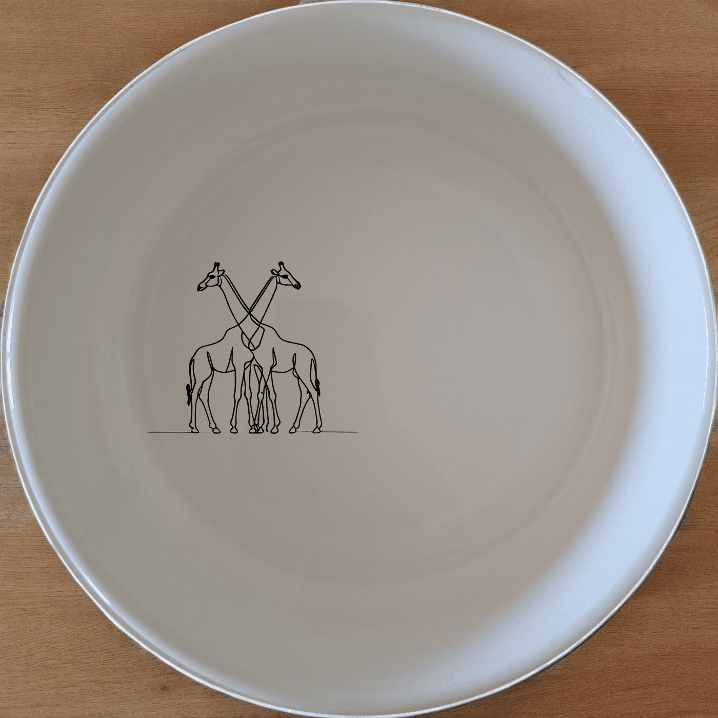 The Elongated Intertwined Girraffes Bowl Set of 4 features a unique design of intertwined giraffes, perfect for adding a touch of nature to your dining experience.