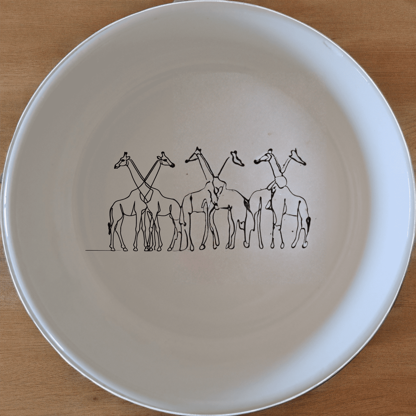 The Elongated Intertwined Girraffes Bowl Set of 4 features a unique design of intertwined giraffes, perfect for adding a touch of nature to your dining experience.