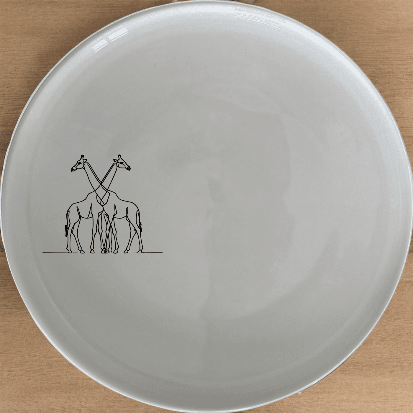 The Elongated Intertwined Giraffes Dinner Plate Set of 4 features a unique design perfect for modern dining.
