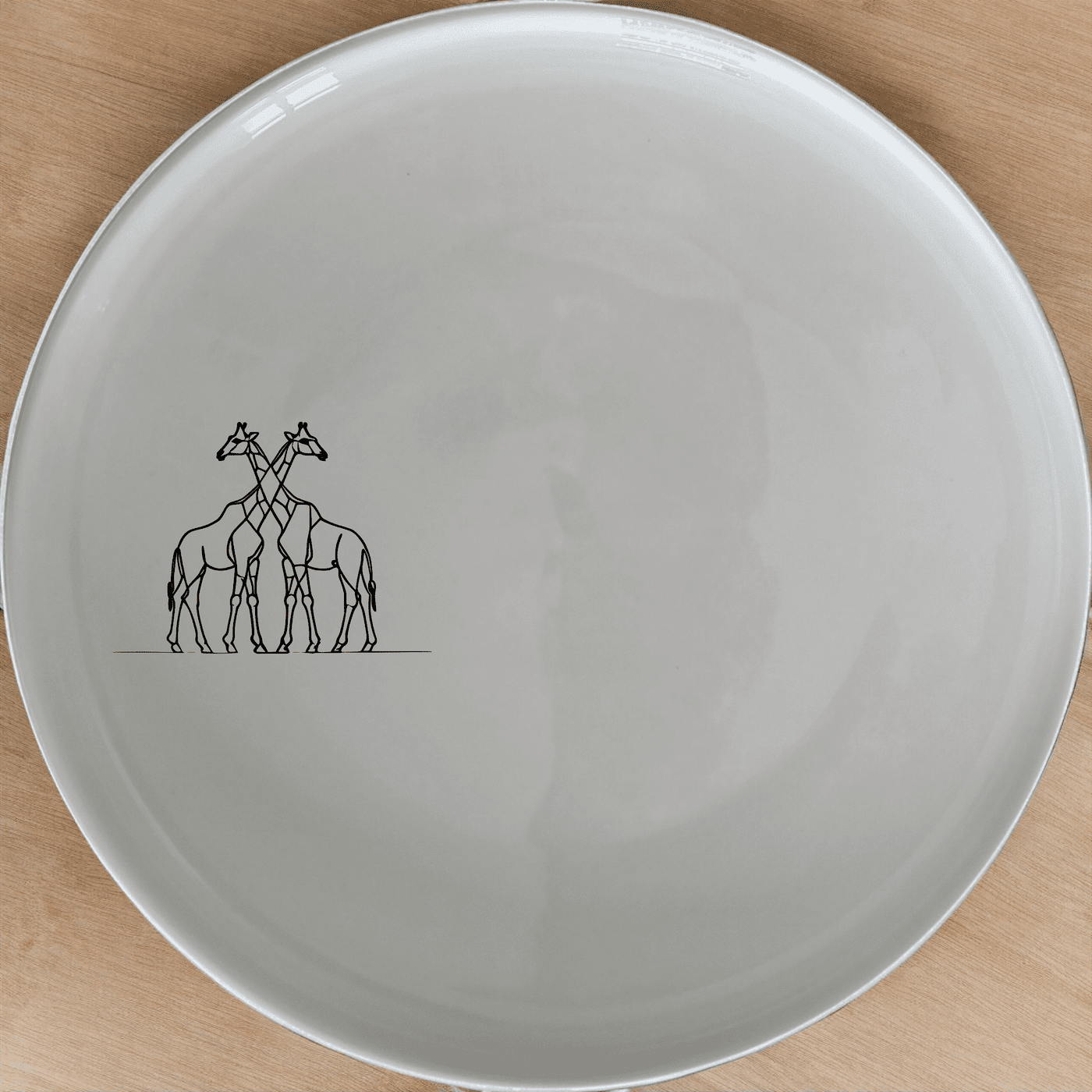 The Elongated Intertwined Giraffes Dinner Plate Set of 4 features a unique design perfect for modern dining.