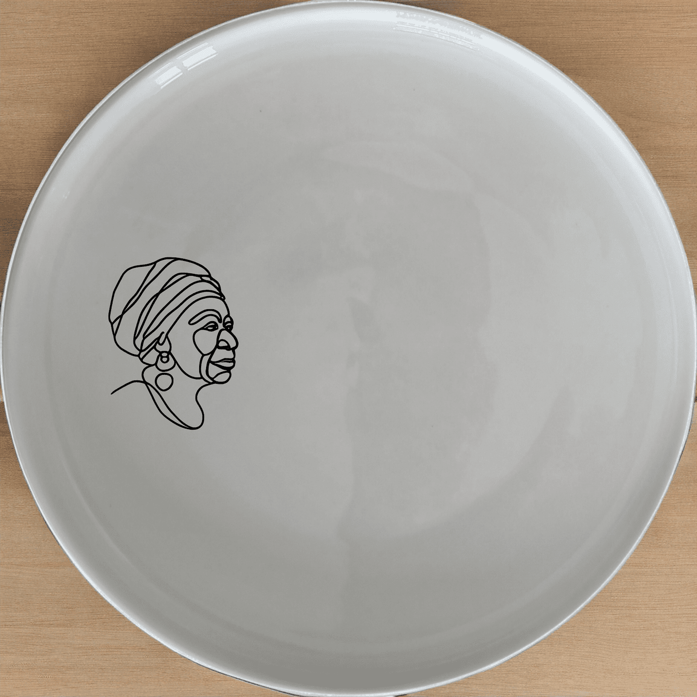 The Face Of Old African Woman Side Plate Set of 4 features a striking and culturally rich design, perfect for adding an artistic touch to your dining experience.