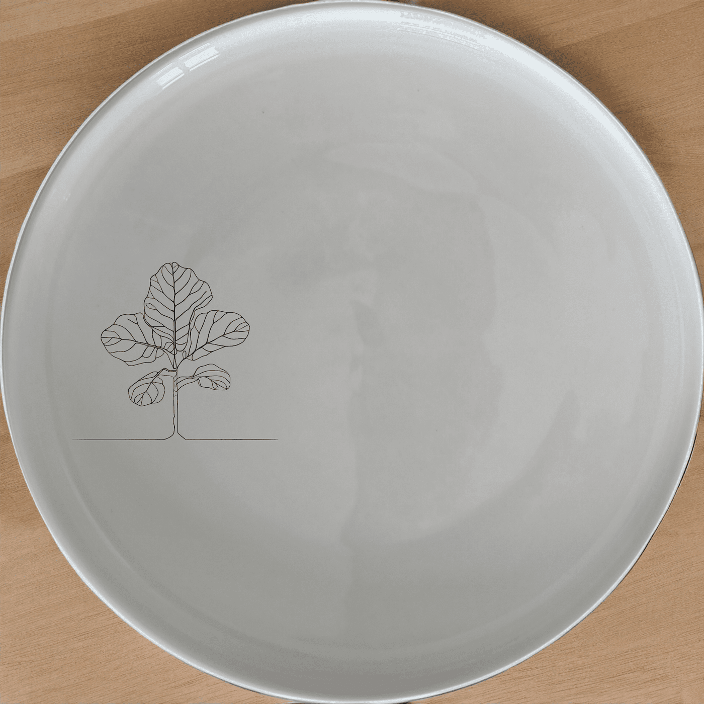 The Fiddle Leaf Dinner Plate Set of 4 features a minimalist design perfect for modern dining. Crafted from durable ceramic, these plates are microwave and dishwasher safe, making them ideal for everyday use.