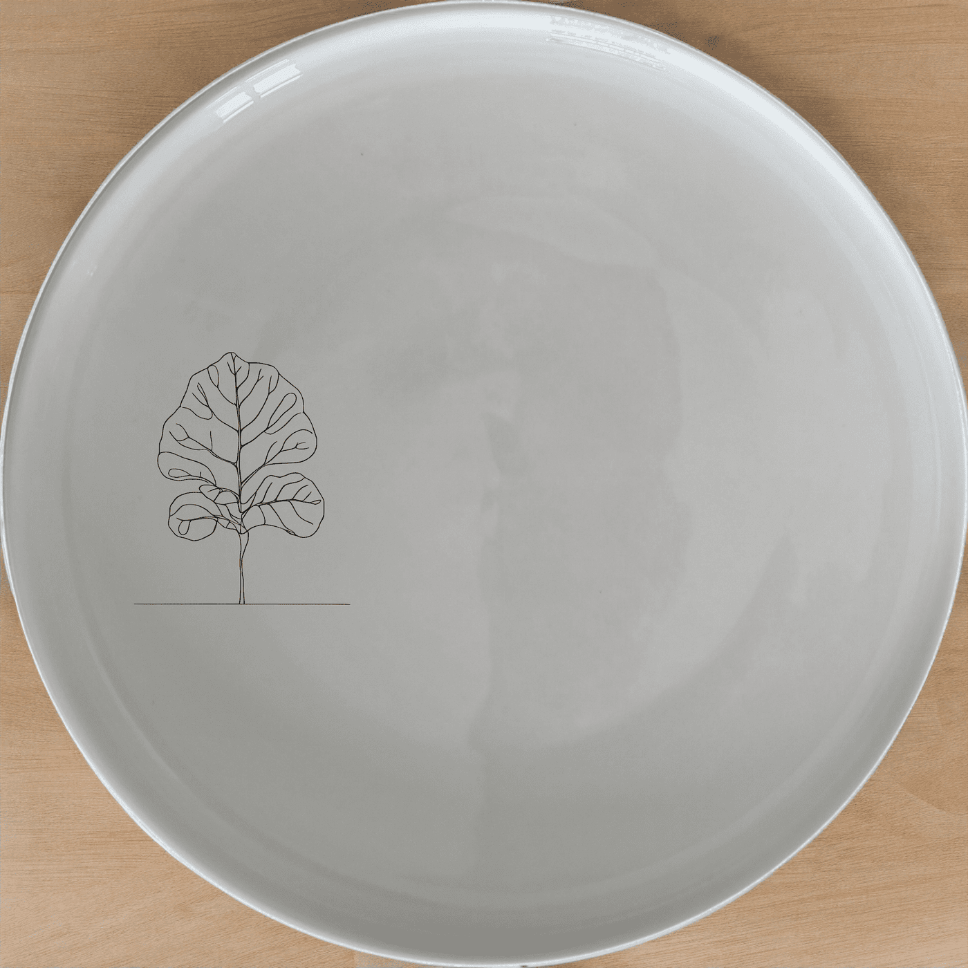 The Fiddle Leaf Side Plate Set of 4 features a minimalist design with an elegant silhouette, perfect for modern dining and everyday use.