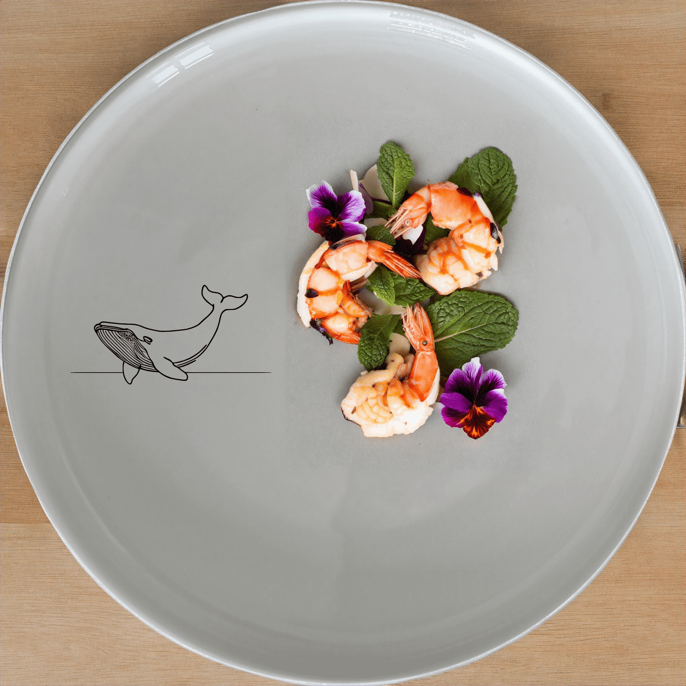 The Floating Breaching Whale Dinner Plate Set of 4 features a minimalist silhouette design, perfect for modern dining settings.