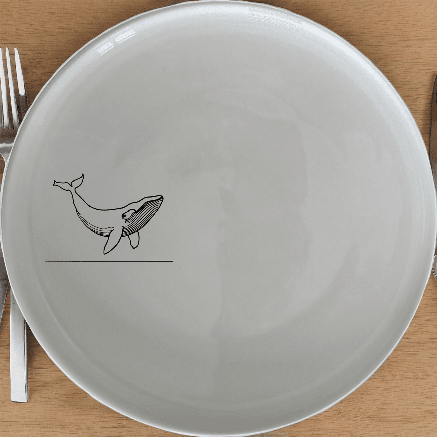 The Floating Breaching Whale Dinner Plate Set of 4 features a striking silhouette of a breaching whale, perfect for adding an artistic touch to your dining experience.