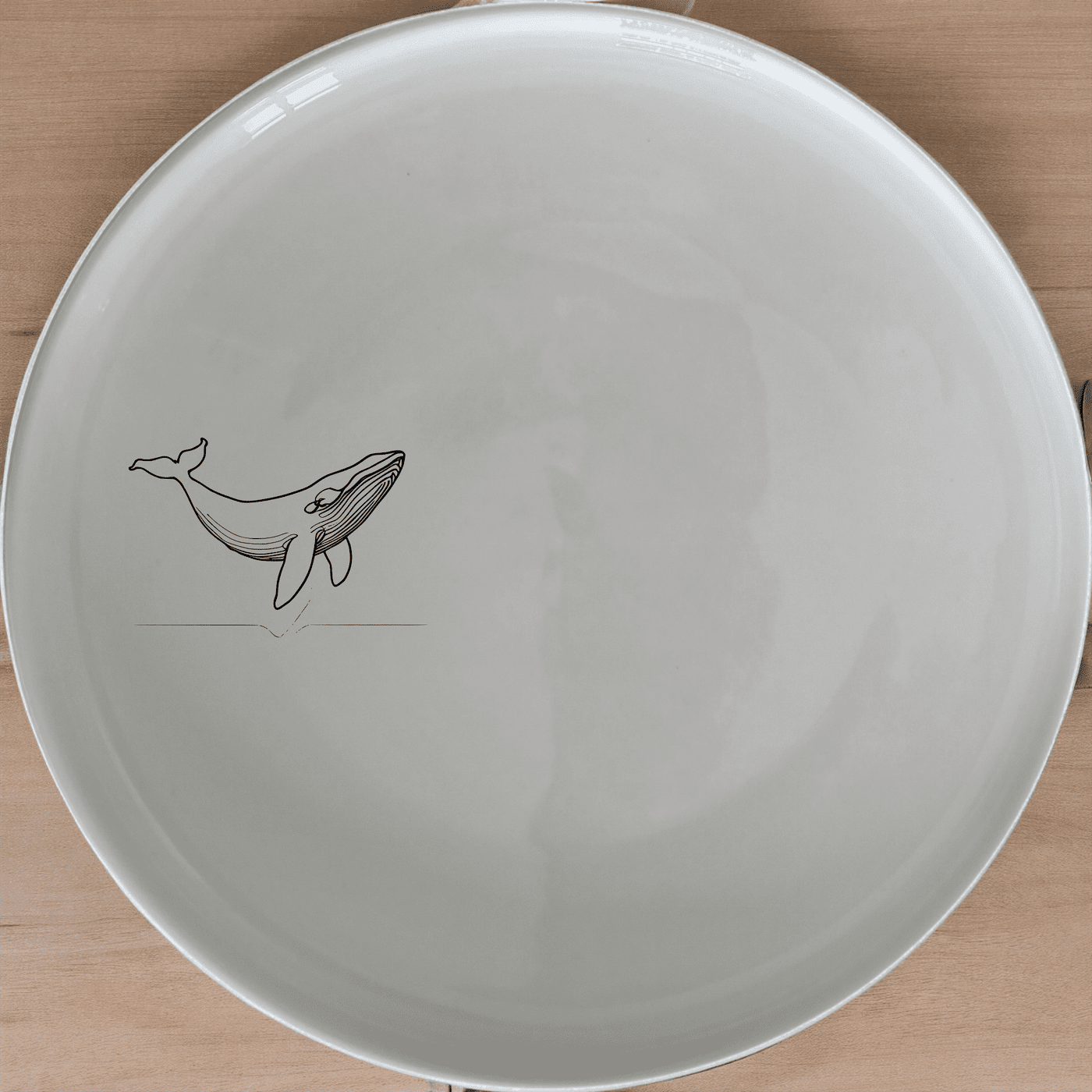 Floating Breaching Whale Dinner Plate Set of 4 adds a touch of marine elegance to your dining table with its sleek design and high-quality ceramic construction.