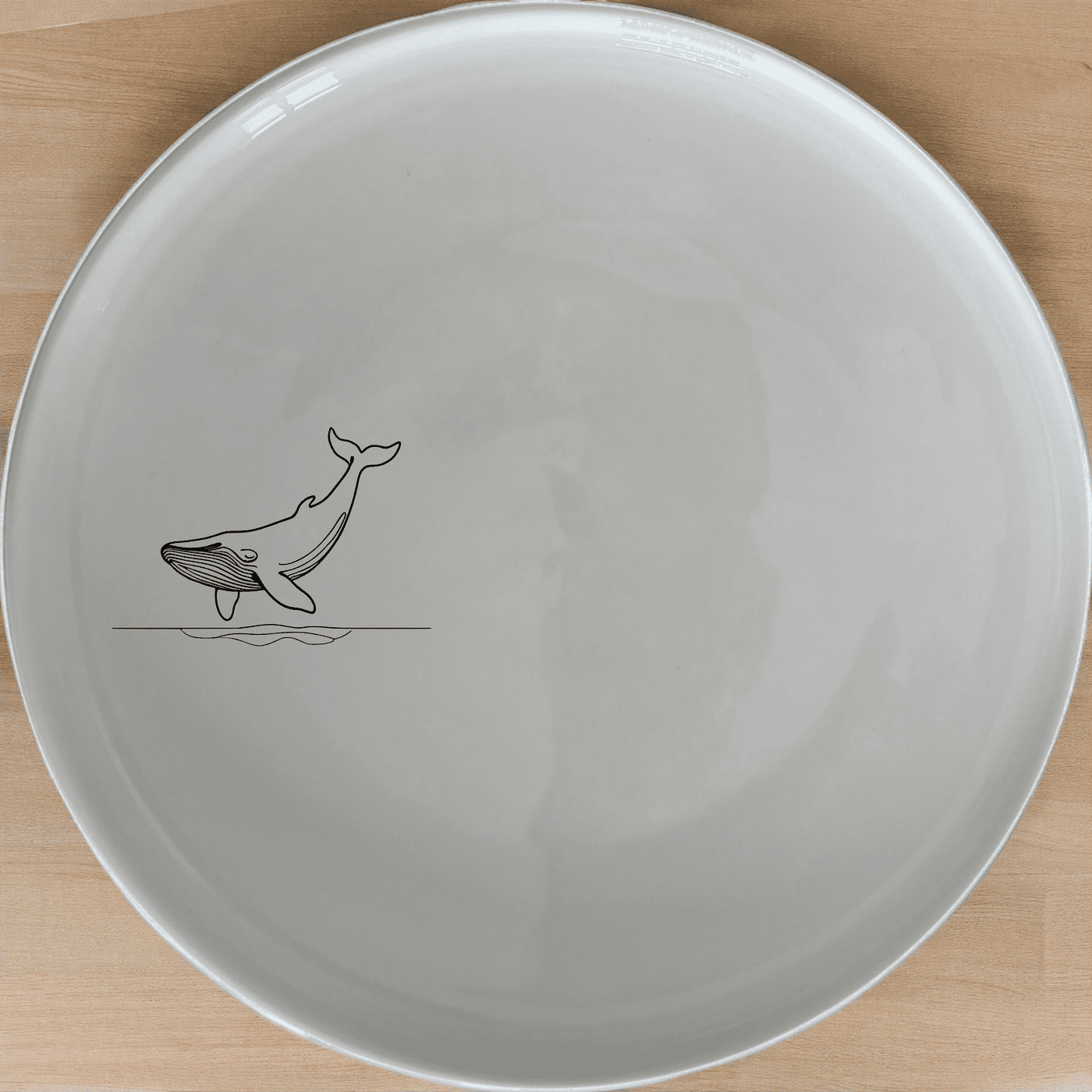 The Floating Breaching Whale Side Plate Set of 4 adds a touch of marine elegance to your dining experience with its sleek, minimalist design.