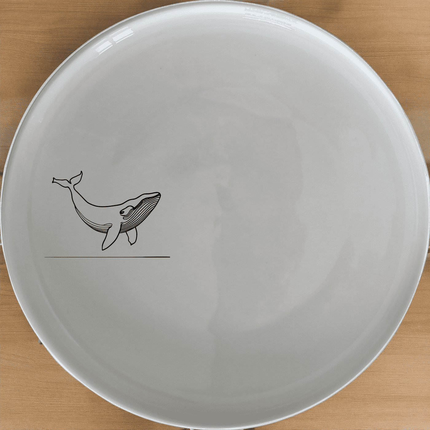 The Floating Breaching Whale Side Plate Set of 4 features a striking silhouette design, perfect for modern dining and adding a touch of nature-inspired elegance to your table.