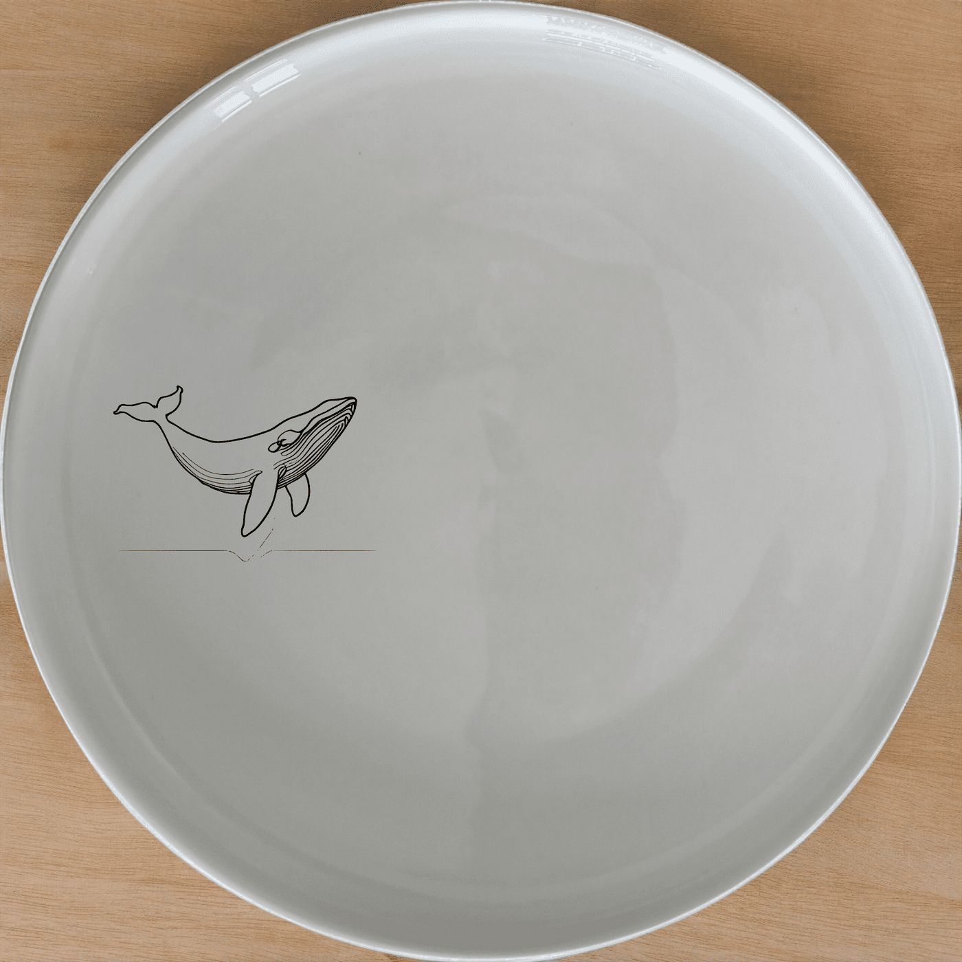 The Floating Breaching Whale Side Plate Set of 4 adds a touch of marine elegance to your dining table with its sleek, minimalist design.