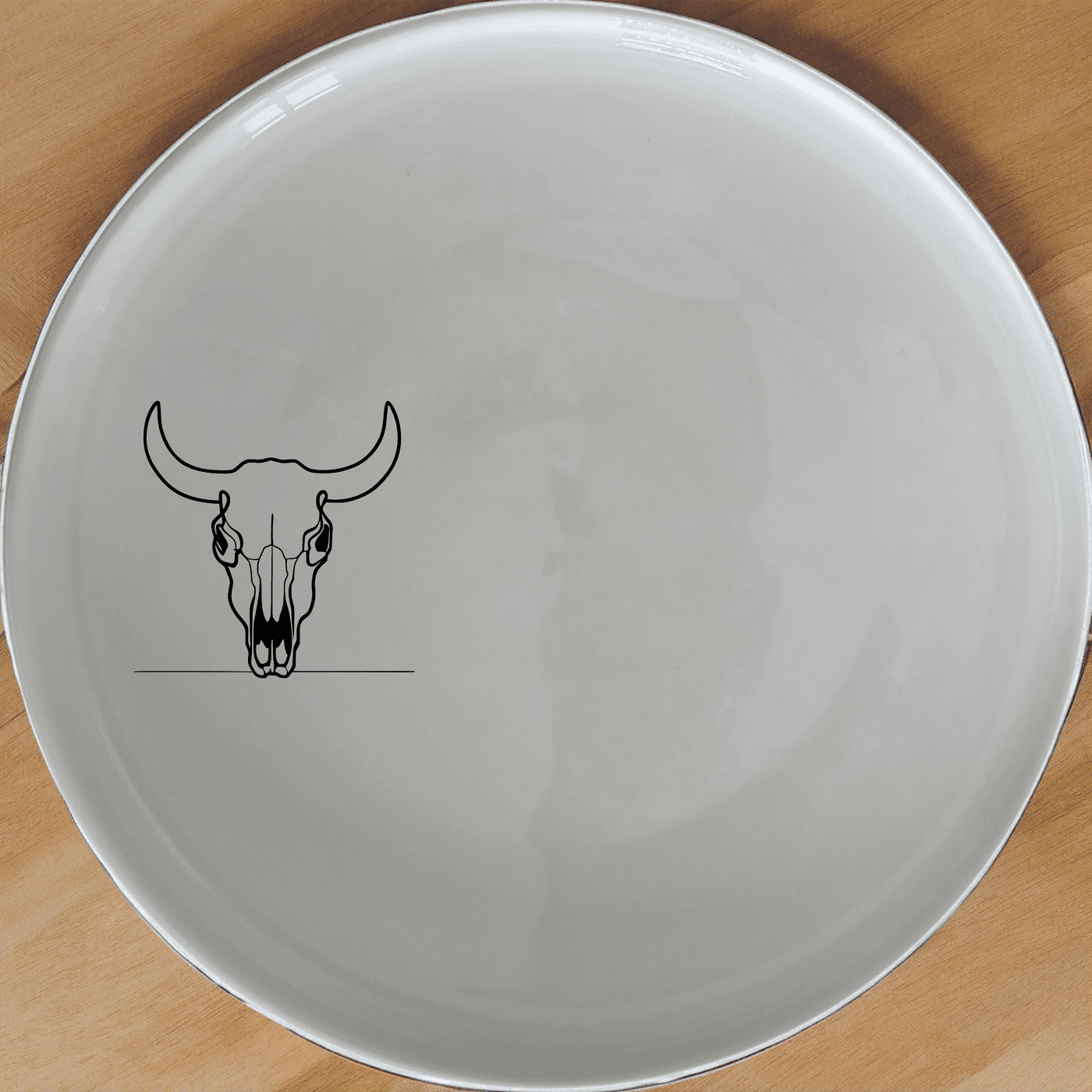 The Front Facing Cow Skull Side Plate Set of 4 adds a bold, artistic touch to your dining table with its striking skull design.