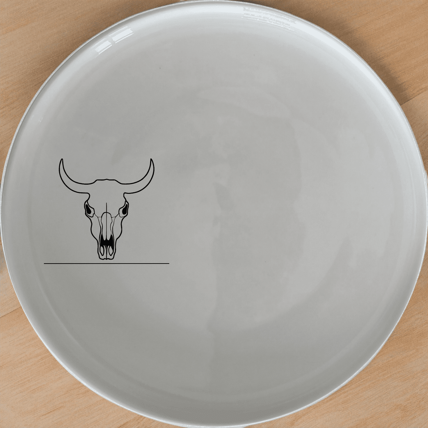 Frontfacing Cow Skull Side Plate Set of 4 is a stylish and modern addition to any dining table, featuring a sleek and minimalist design.