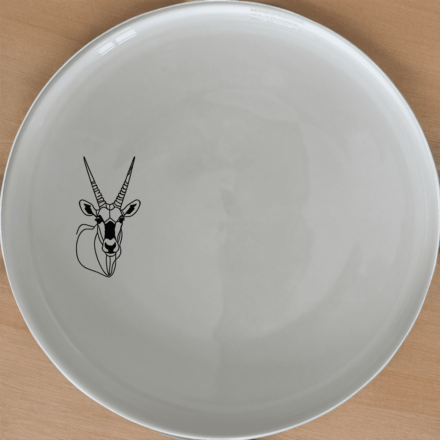 The Gemsbok Bust Dinner Plate Set of 4 features a striking silhouette of the African antelope, perfect for modern dining settings.