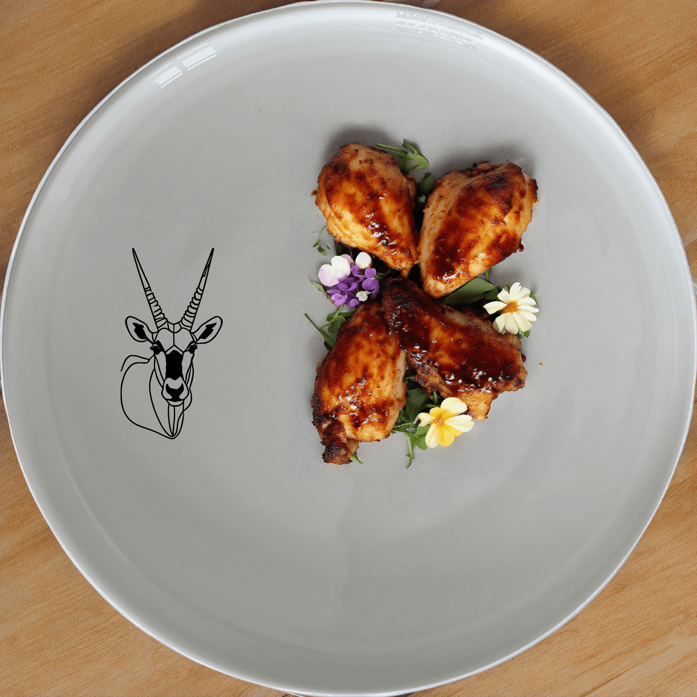 The Gemsbok Bust Side Plate Set of 4 features a striking silhouette of the African antelope, perfect for modern dining and art lovers.