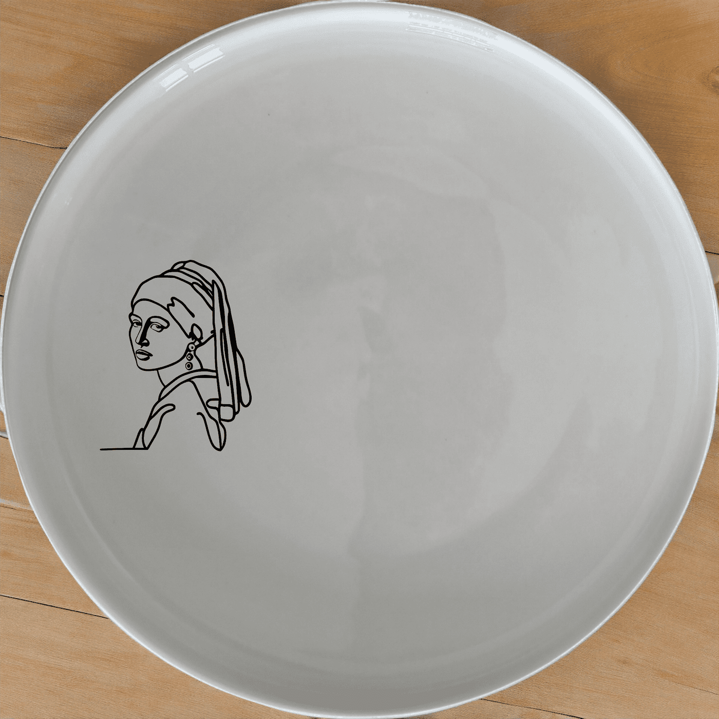 The Girl Pearl Earring Dinner Plate Set of 4 features a timeless design perfect for any dining table. Crafted from premium ceramic, these plates are both microwave and dishwasher safe, making them ideal for everyday use or special occasions.