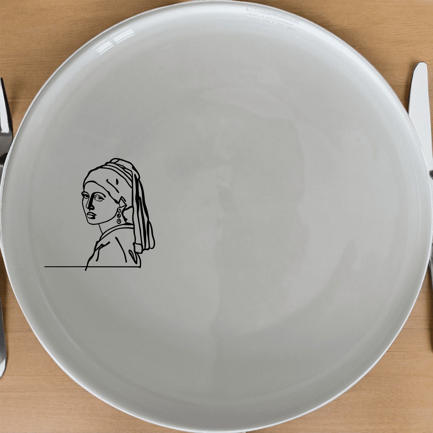 The Girl Pearl Earring Dinner Plate Set of 4 features a minimalist design inspired by classic art, perfect for elevating any dining experience.