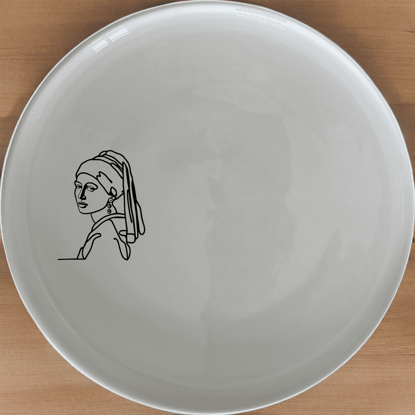 The Girl Pearl Earring Side Plate Set of 4 features a timeless design perfect for any dining table. Crafted from premium ceramic, these plates are both stylish and practical.