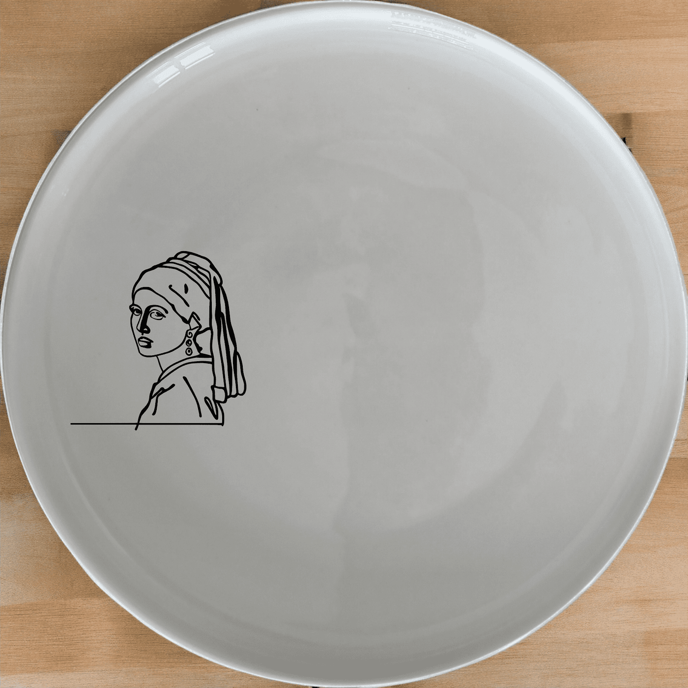 The Girl Pearl Earring Side Plate Set of 4 features a minimalist design inspired by classic art, perfect for modern dining.