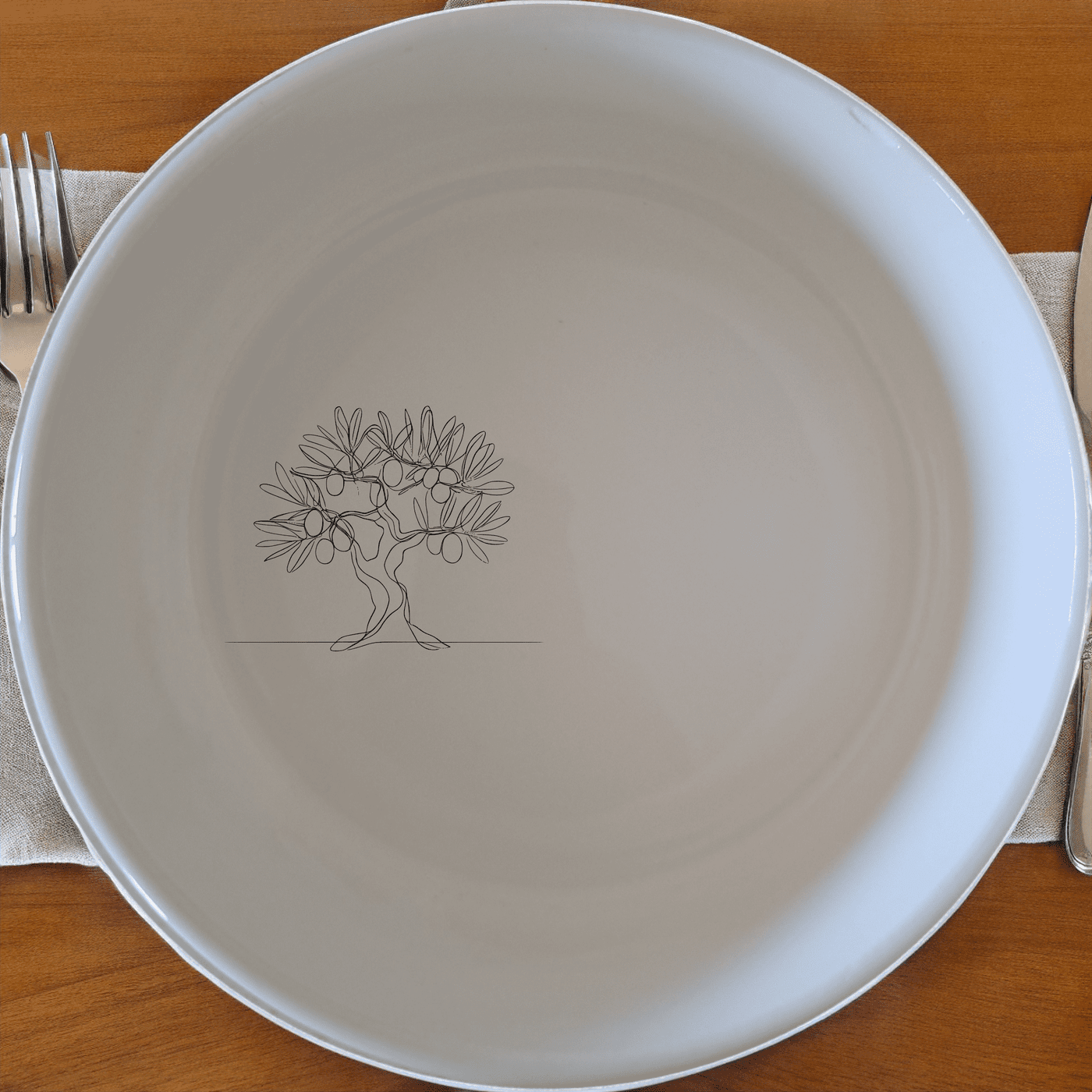 The Grecian Olive Tree Bowl Set of 4 features a minimalist olive tree design, perfect for adding a touch of Mediterranean elegance to your dining experience.