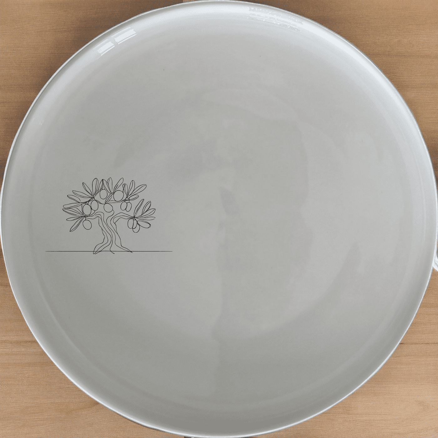 The Olive Tree Dinner Plate Set of 4 features a minimalist design with an olive tree graphic, perfect for modern dining and everyday use.