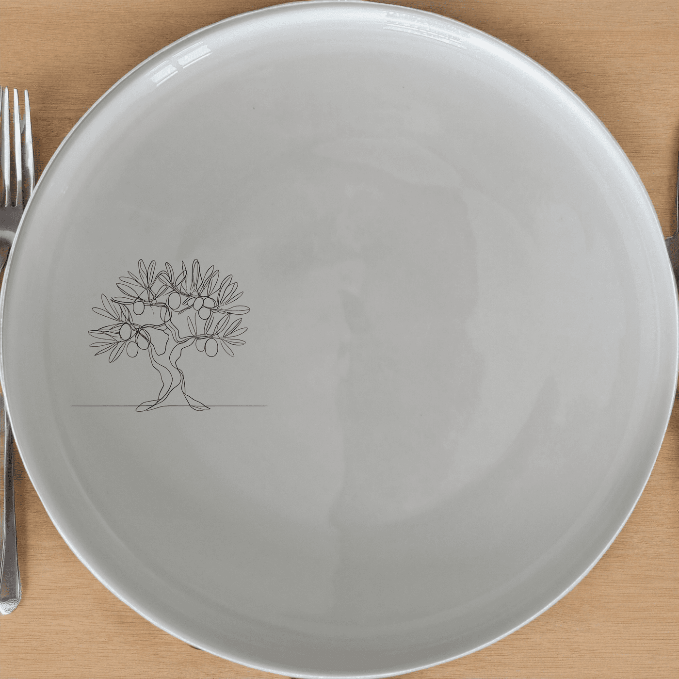 The Olive Tree Dinner Plate Set of 4 features a minimalist design with an olive tree graphic, perfect for modern dining settings.