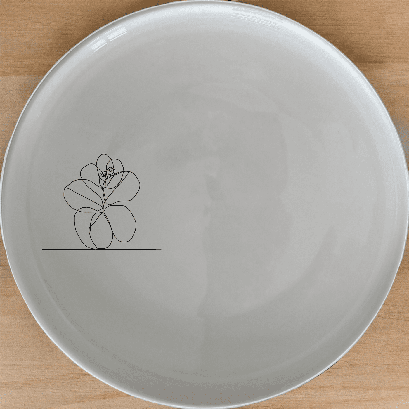 The Hoya Carnosa Dinner Plate Set of 4 features a delicate laser-etched floral design on a sleek white ceramic surface, perfect for elevating any dining experience.