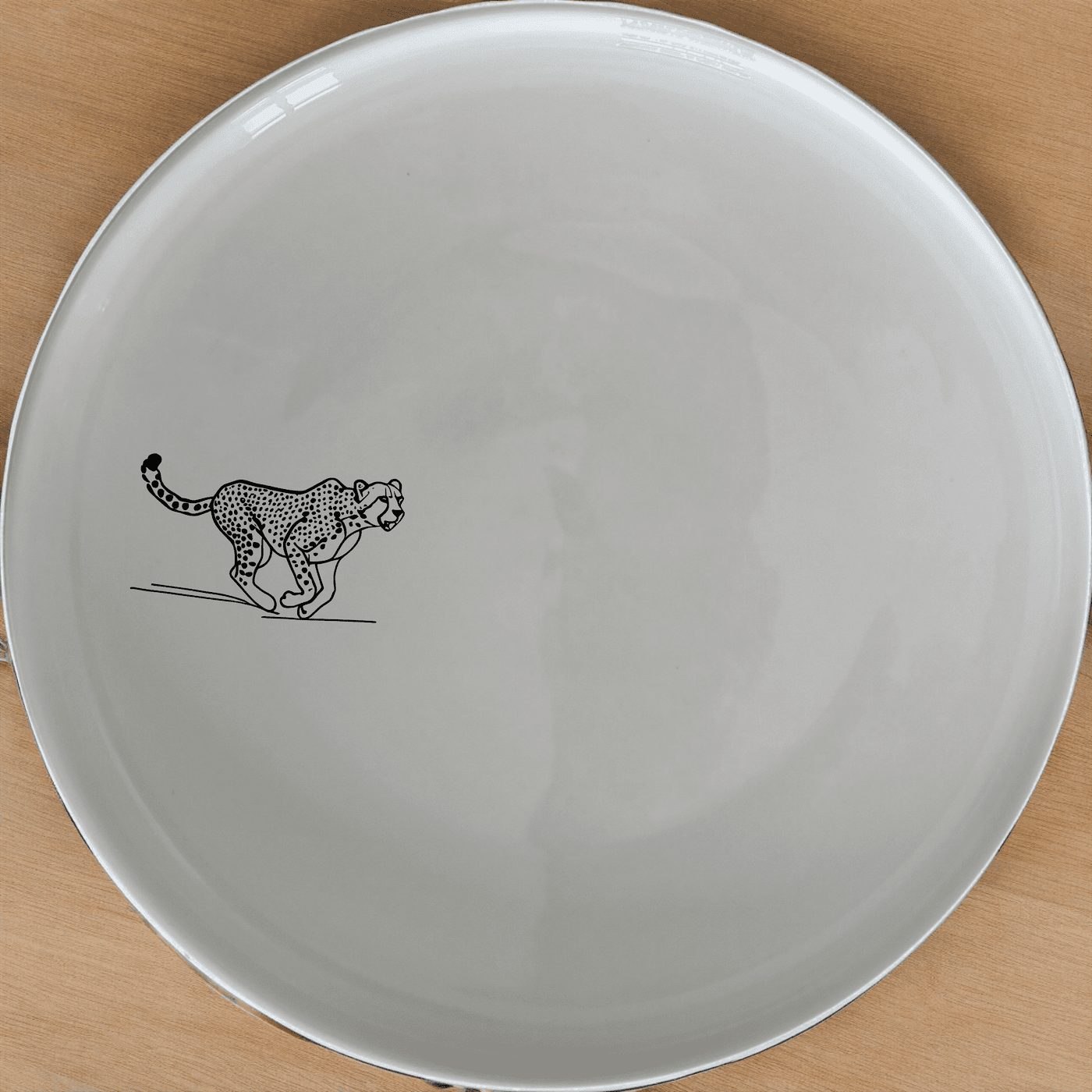 The Running Cheeta Dinner Plate Set of 4 - Range 4 features a sleek cheetah design, perfect for modern dining. Crafted from durable ceramic, these plates are microwave and dishwasher safe, making them ideal for everyday use.