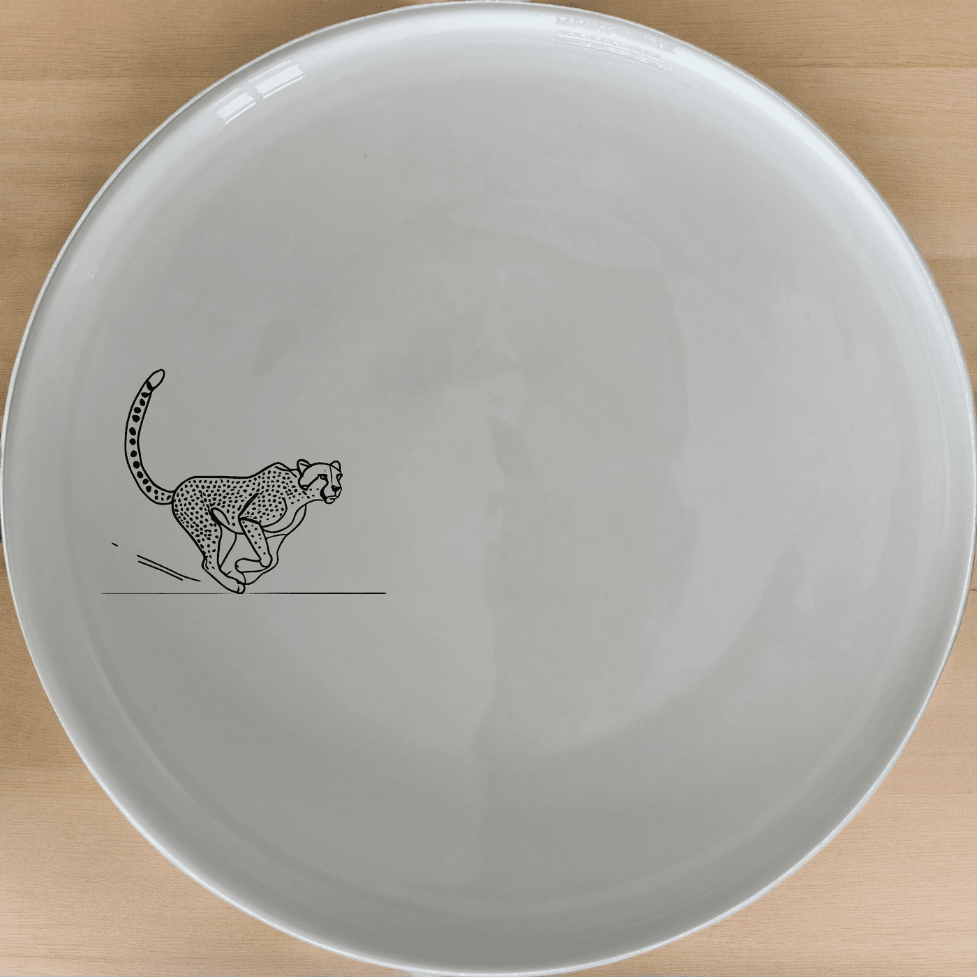 The Running Cheeta Side Plate Set of 4 - Range 1 features a sleek cheetah design, perfect for adding a touch of wildlife elegance to your dining table.