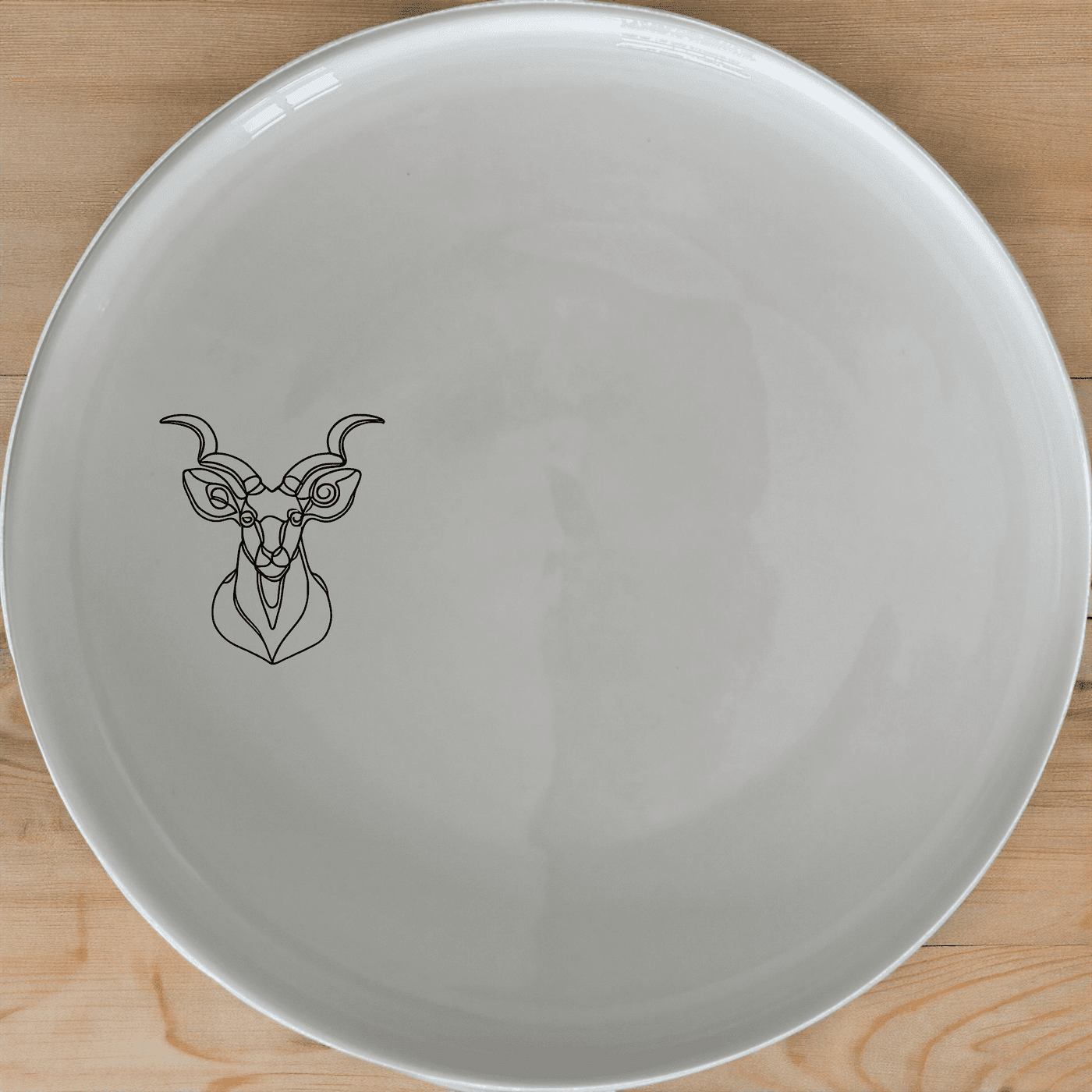 The Kudu Spiral Horns Dinner Plate Set of 4 features elegant wildlife artwork for a sophisticated dining experience.