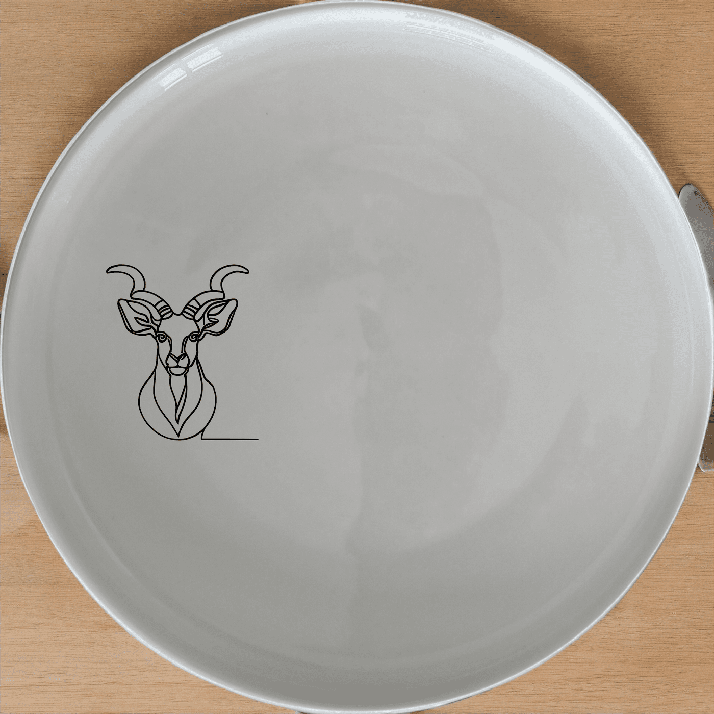 The Kudu Spiral Horns Majestic Bust Side Plate Set of 4 features elegant wildlife artistry in a modern, minimalist design perfect for any dining setting.