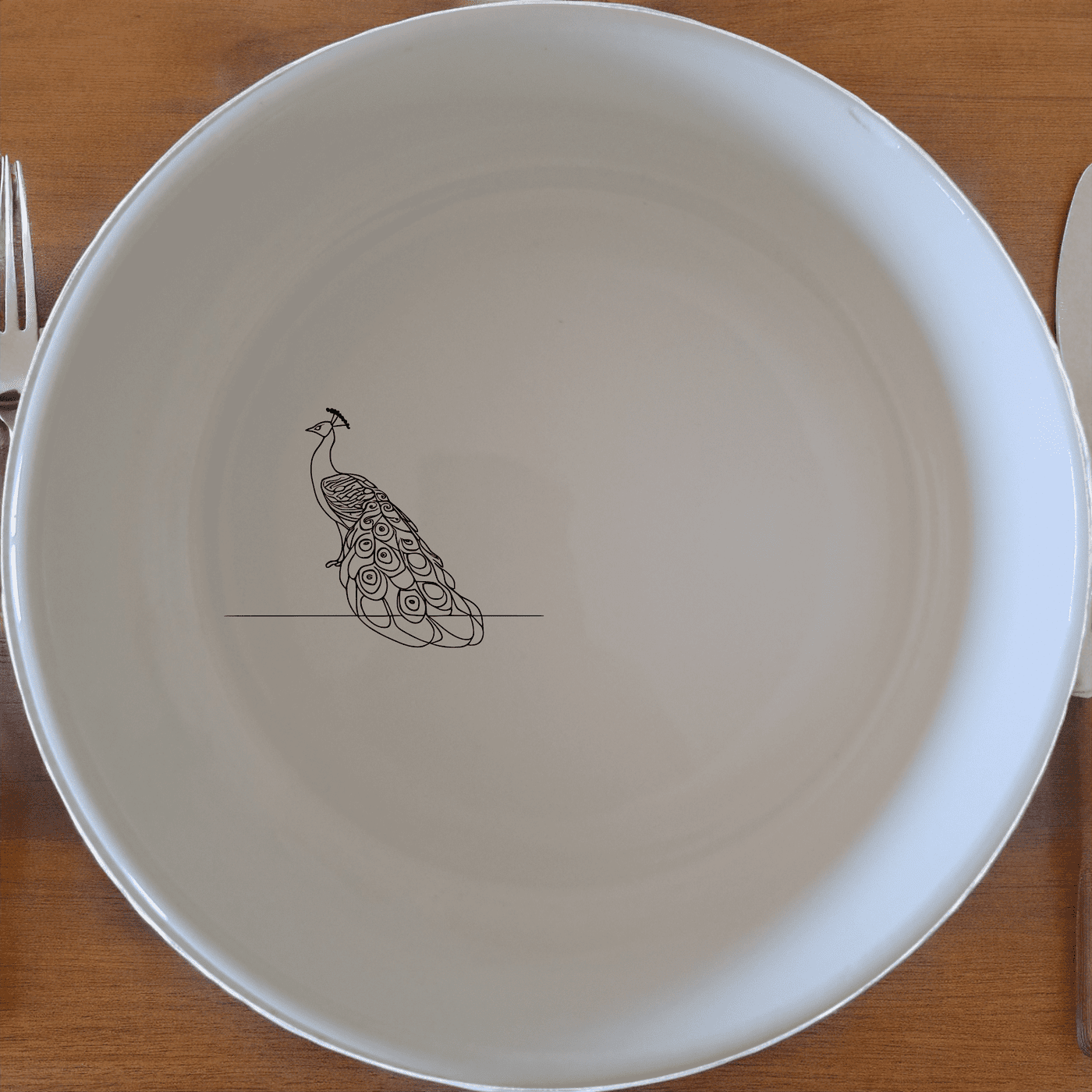 The Male Peacock Flat Bowl Set of 4 adds a touch of elegance to your dining table with its intricate design and classic white ceramic finish.
