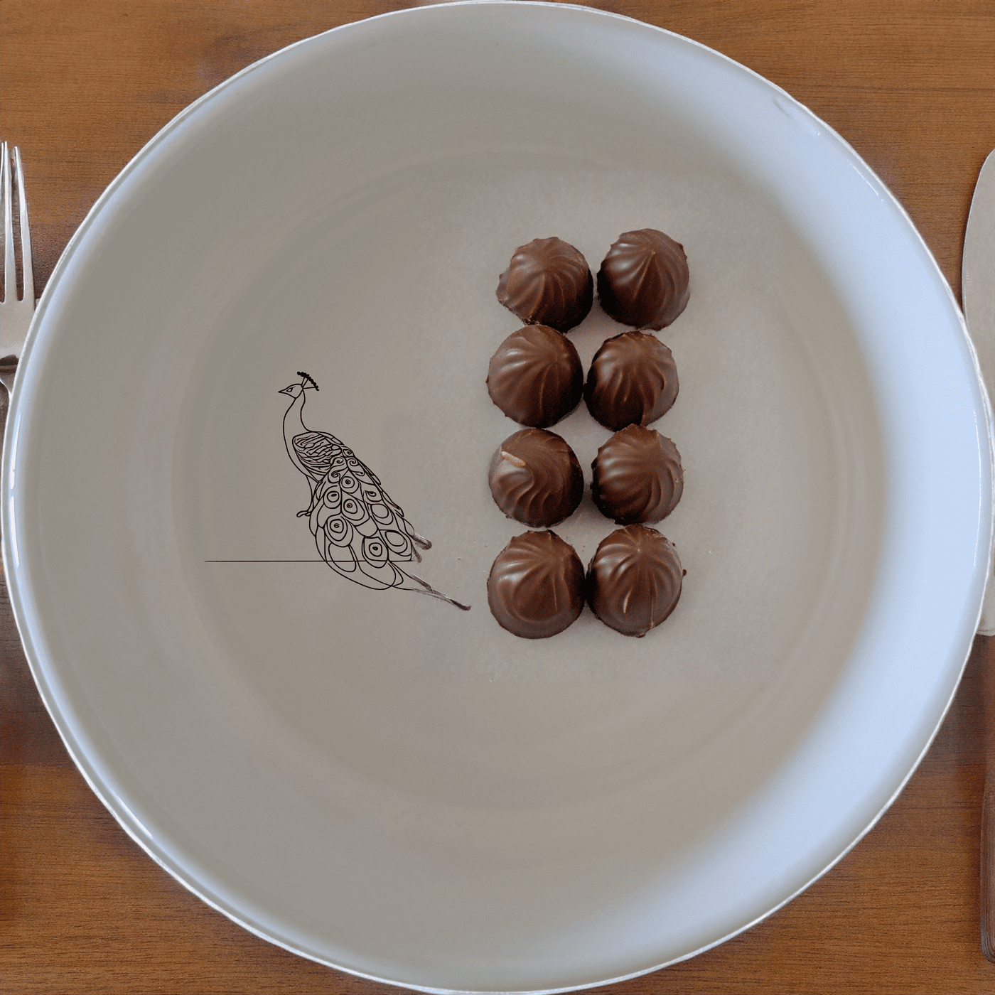 The Male Peacock Flat Bowl Set of 4 adds a touch of elegance to your dining table with its intricate design and classic white ceramic finish.